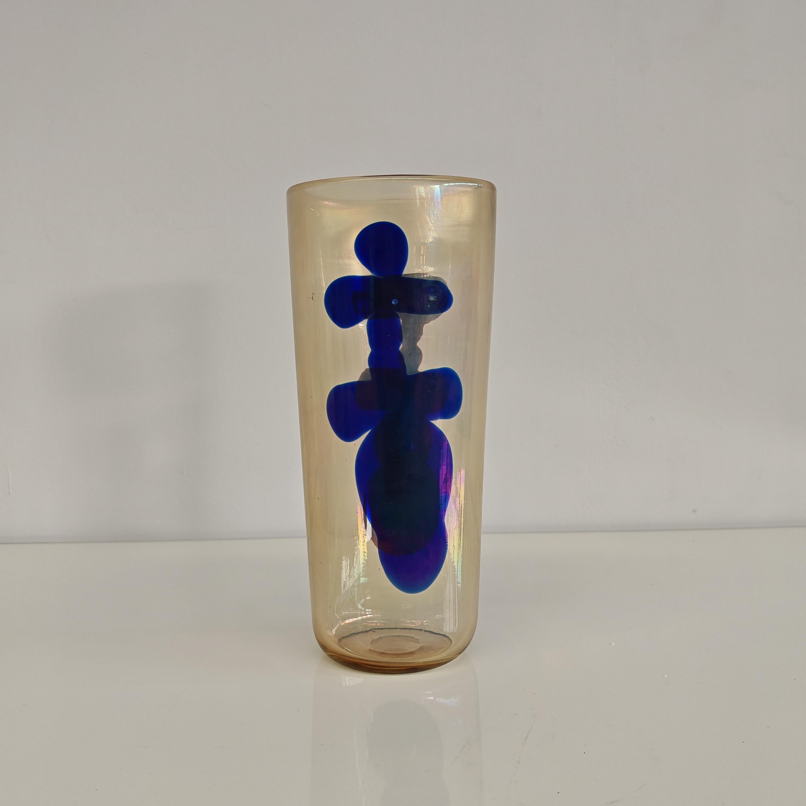 Rare slightly amber and iridescent glass vase with black figure in one side and blue in the other.
This art glass belongs to the 
