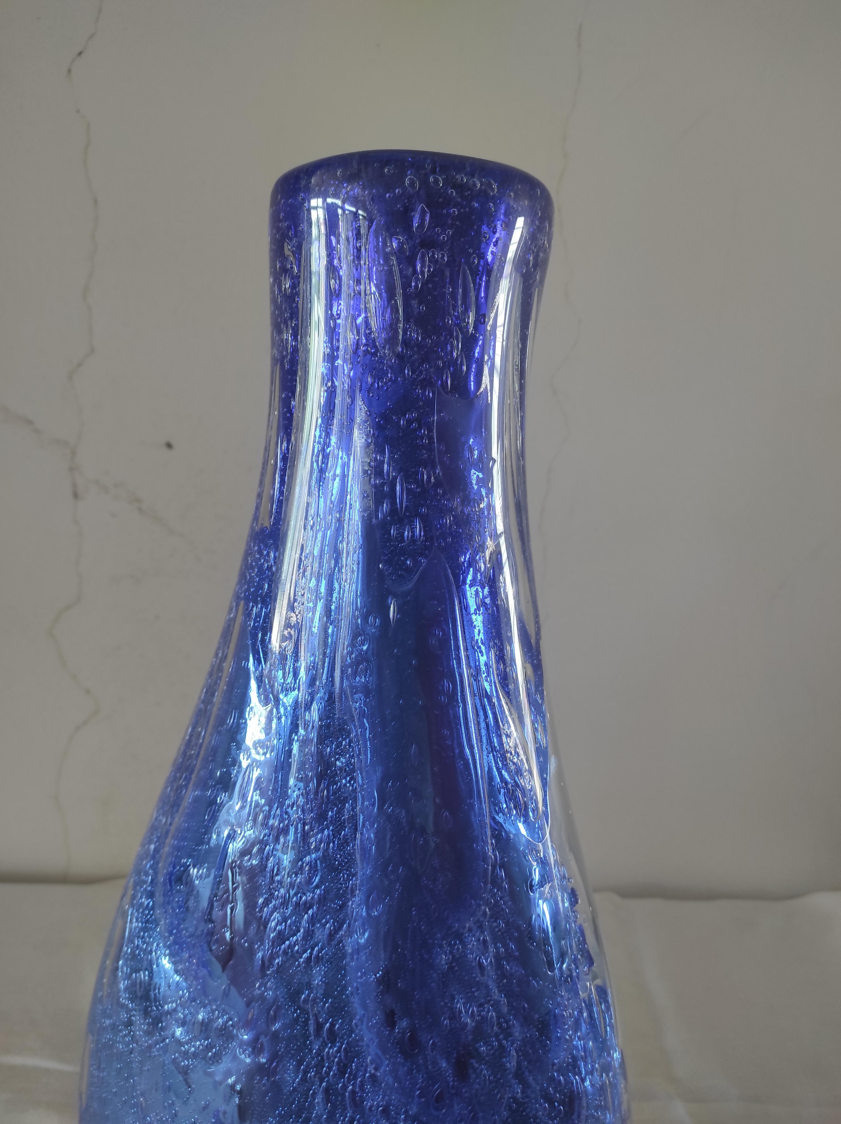 This vase was made by Sergio Costantini a Murano master. It is a blue reminiscent of the ocean the most beautiful depths of an ocean.Two techniques are used.The first of silver leaf on glass, used by artists and craftsmen mainly during the