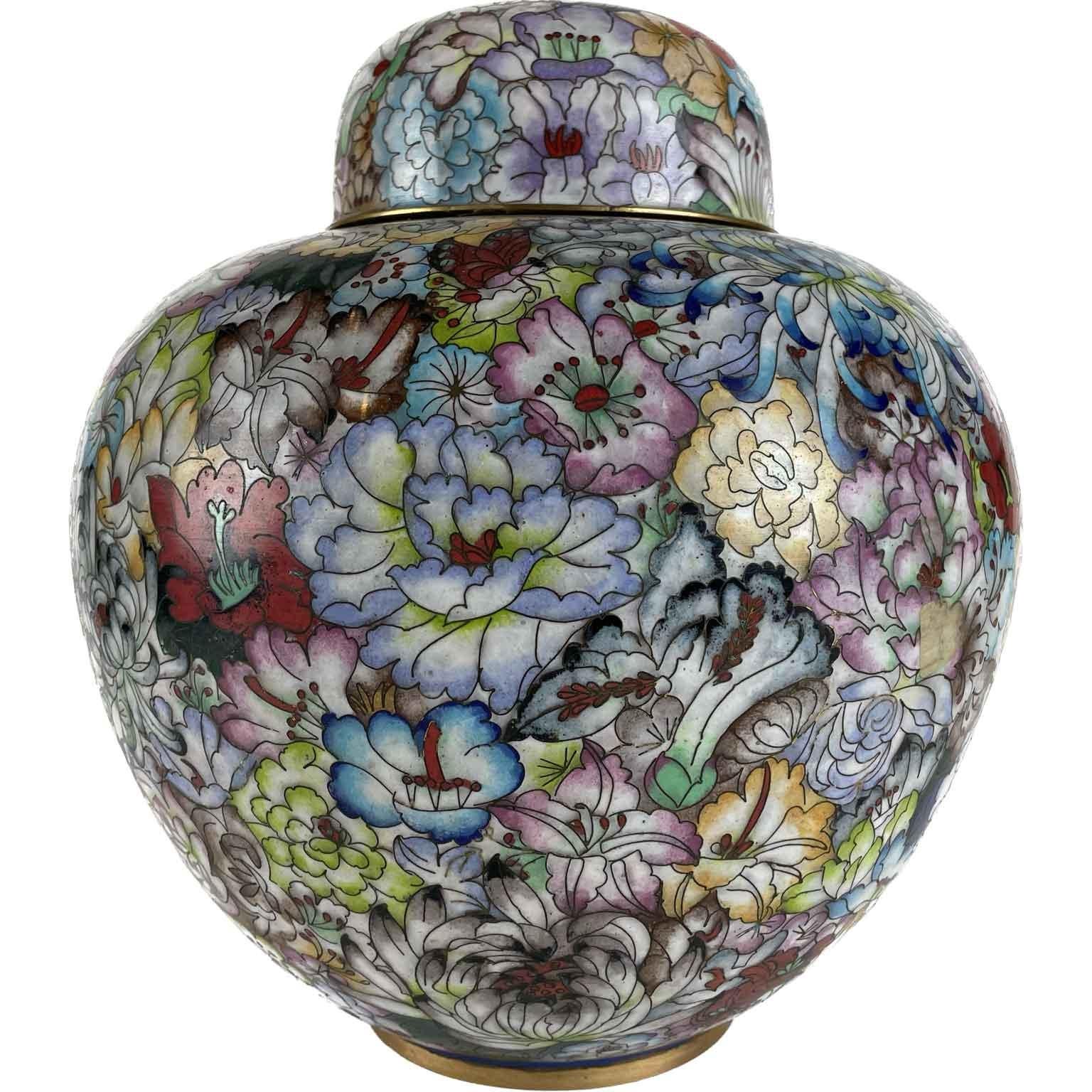 Cloisonné vase with lid with rich floral decoration, peonies and butterflies, light blue background of the  mid-twentieth century, of Chinese origin.  Belly-shaped,  of remarkable quality the floral design the polychrome coloring of the enamels.