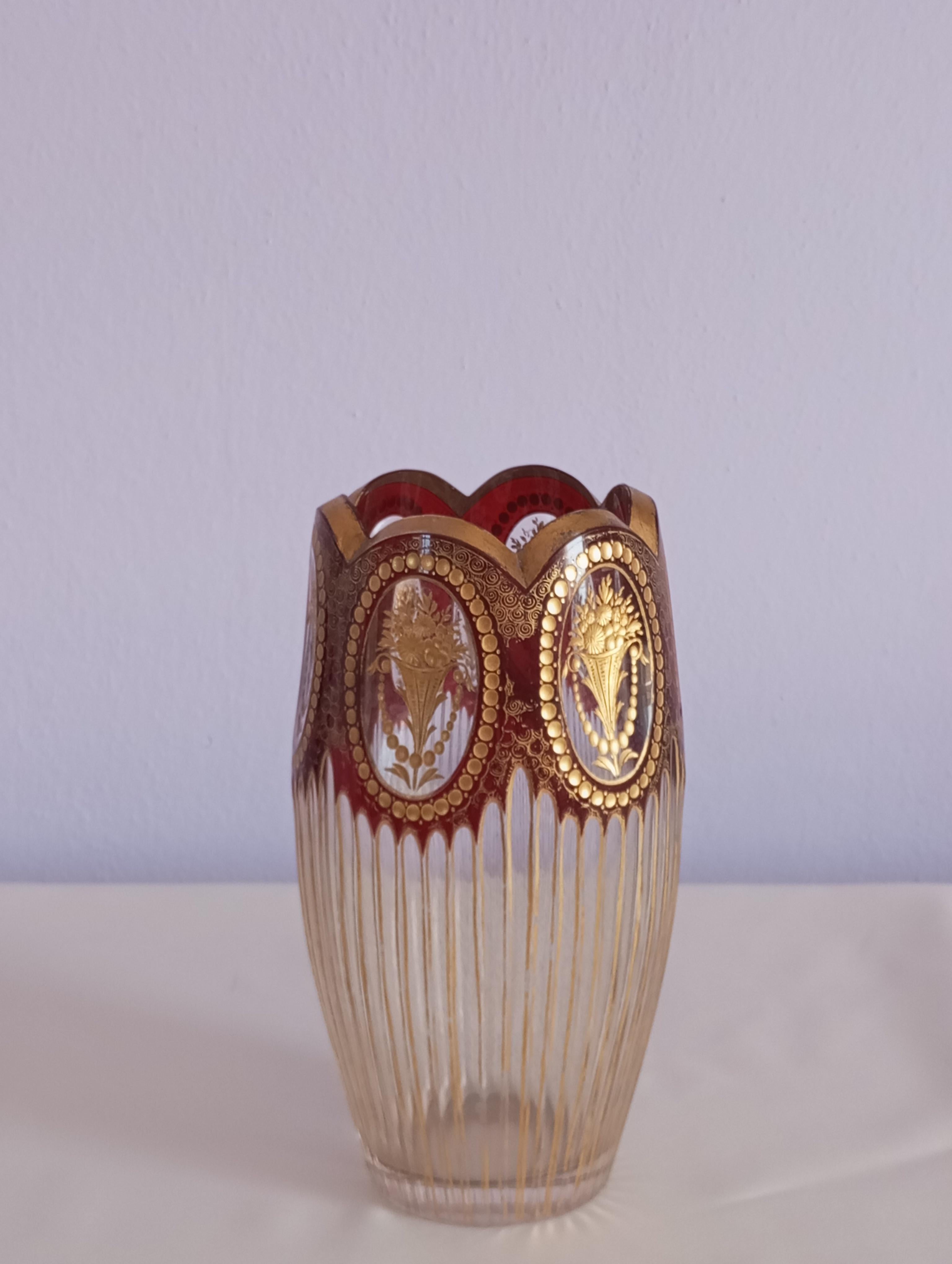 This beautiful decorative beveled glass vase is worked with elaborate details and engravings  bohemia in the early 20th century. 
The top of the vase has a shaped rim with gold ornaments. The gold decorations are inside medallions with small circle
