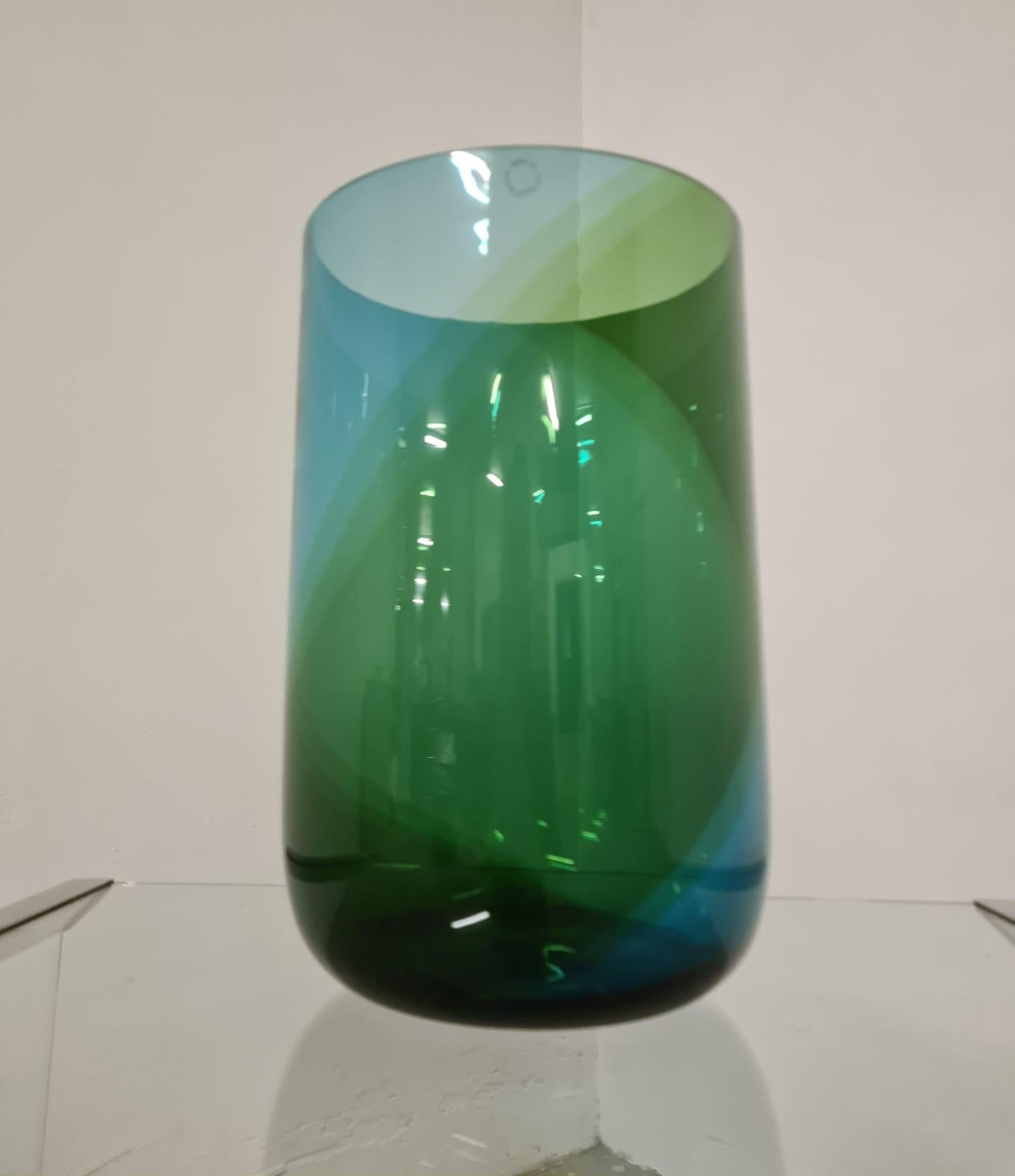 Vase from the Coreani series designed by Tapio Wirkkala for Venini.

Elegant collectible blown glass vase with blue and green bands that create a spiral with overlapping colors and shades.

Model 505.5 from the Venini catalog.

The Korean series