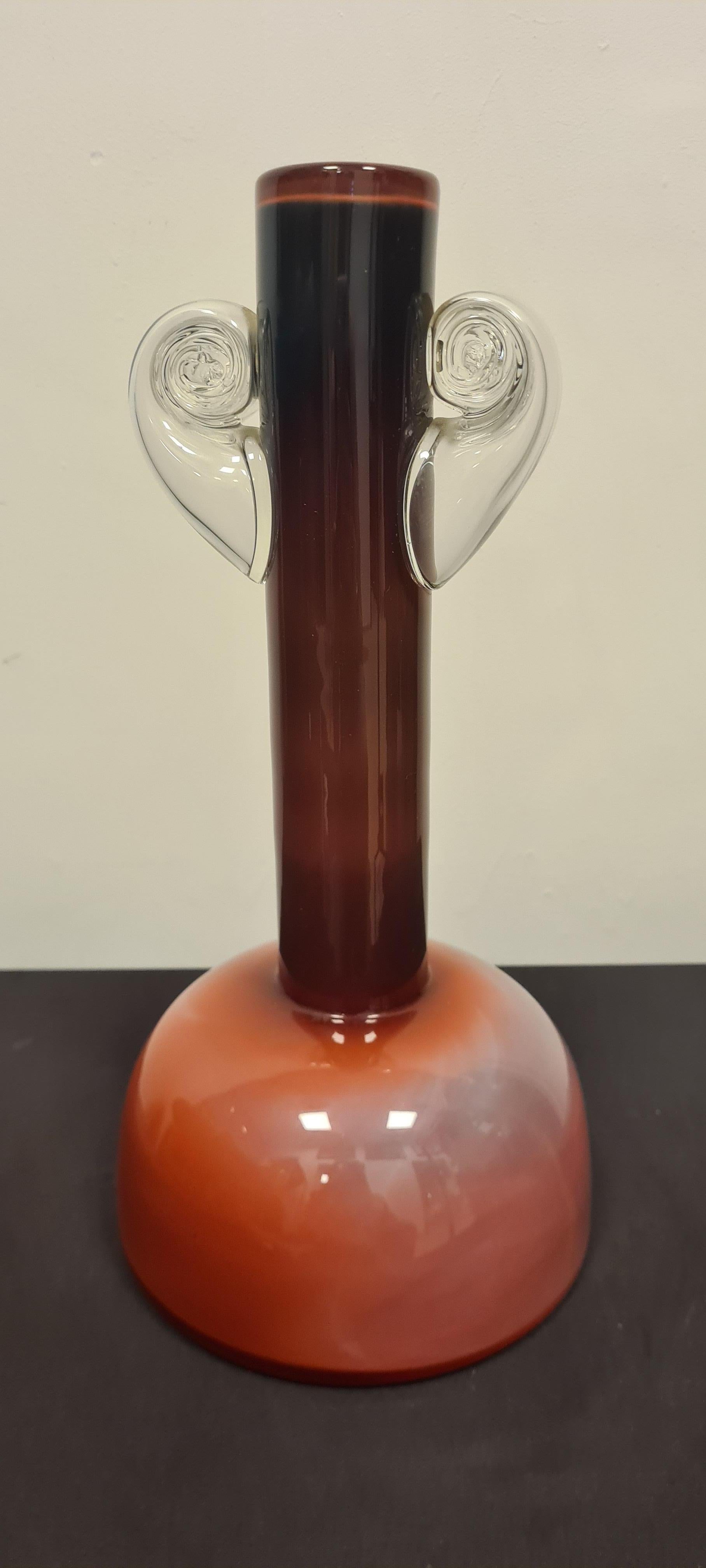 Vase by Jerzy Słuczan-Orkusz for Tarnowiec.

Refined opaline glass vase encapsulated by burgundy shaded glass and expertly twisted clear glass handles.

Designed by Polish master glassmaker Jerzy Słuczan-Orkusz whose works are also exhibited in the