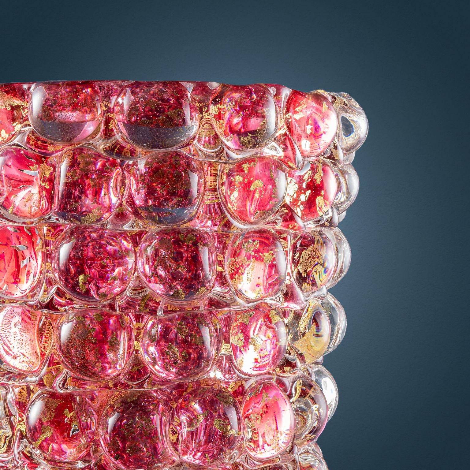 Cylindrical Murano glass ruby and gold leaf vase with mold-obtained hemispheres decoration.
Designed by Ercole Barovier for a Barovier & Toso production, 'Lenti' series.

Signed 