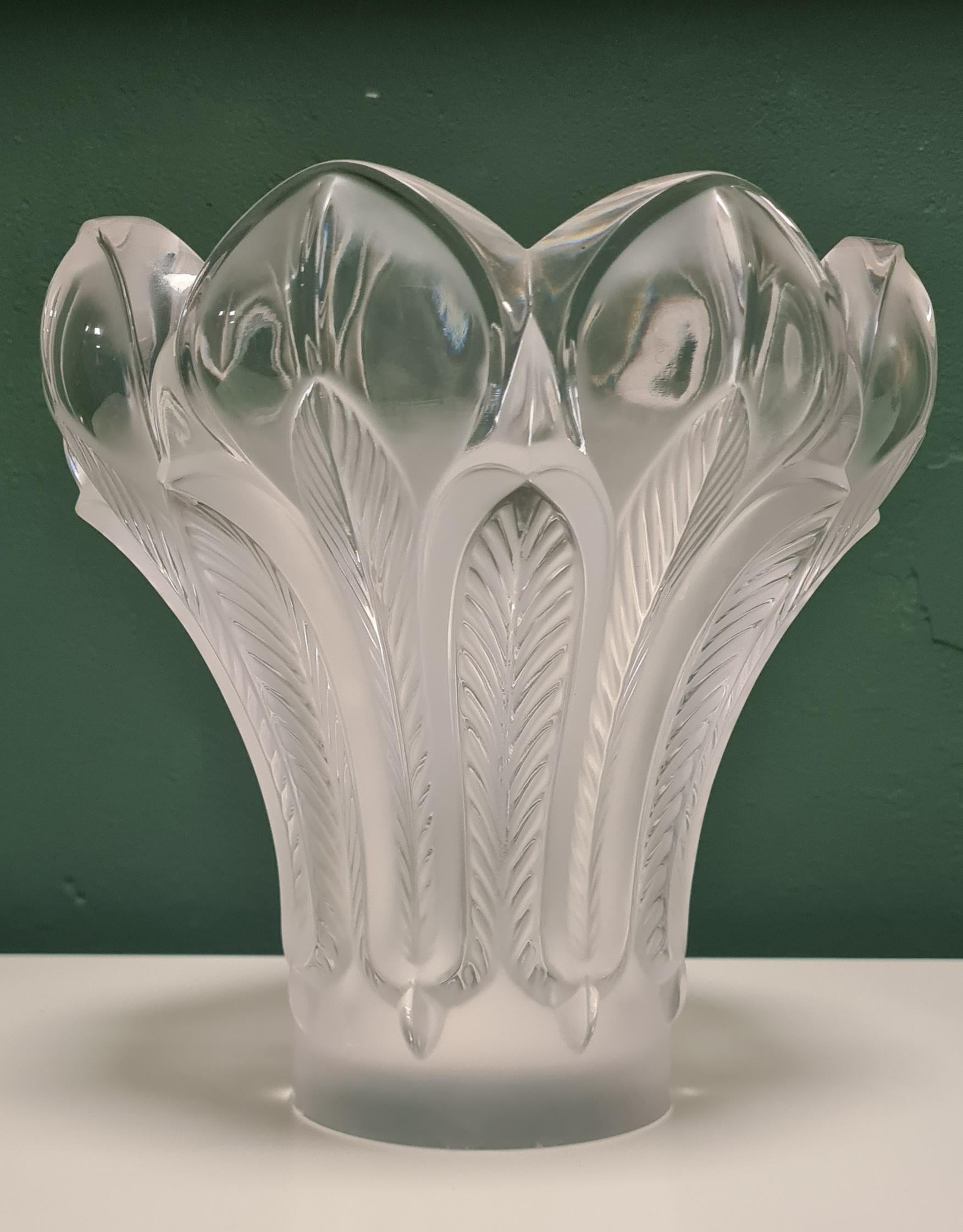 Vase created by the Lalique glassworks.

Made in 1985 to commemorate the 125th anniversary of Rène Lalique's birth.

It has transparent parts alternated with stylized, satiny feathers that give the vase the shape of an open flower.

The vase is