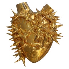 Golden ceramic vase with heart-shaped design