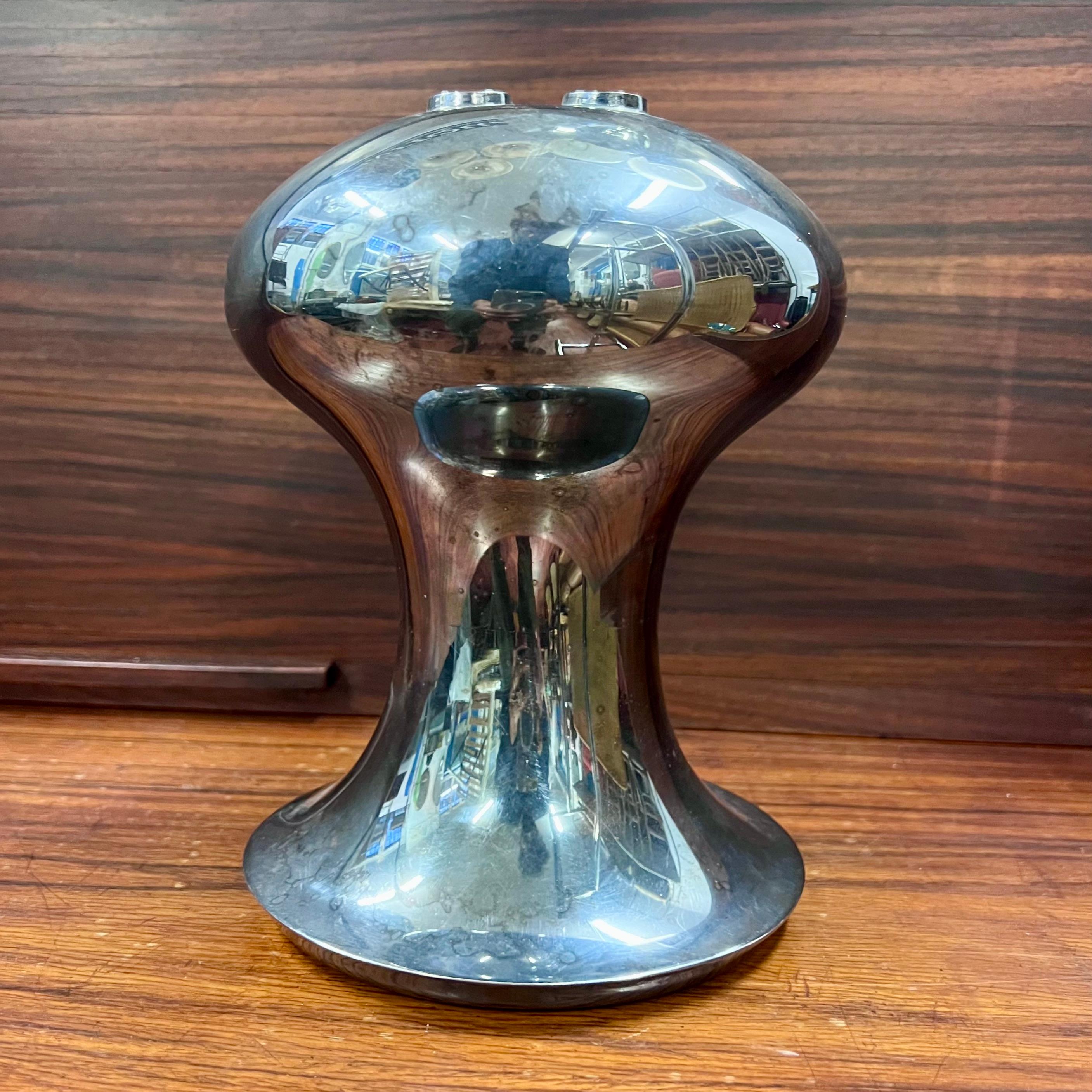 Rare silvered metal vase with a distinctive shape, designed for Sabattini Argenterie, by Lino Sabattini, in the 1970s.
In fact, the shape brings back the Space Age style, recalling a Space Base from the collective imagination. 
It bears the brand