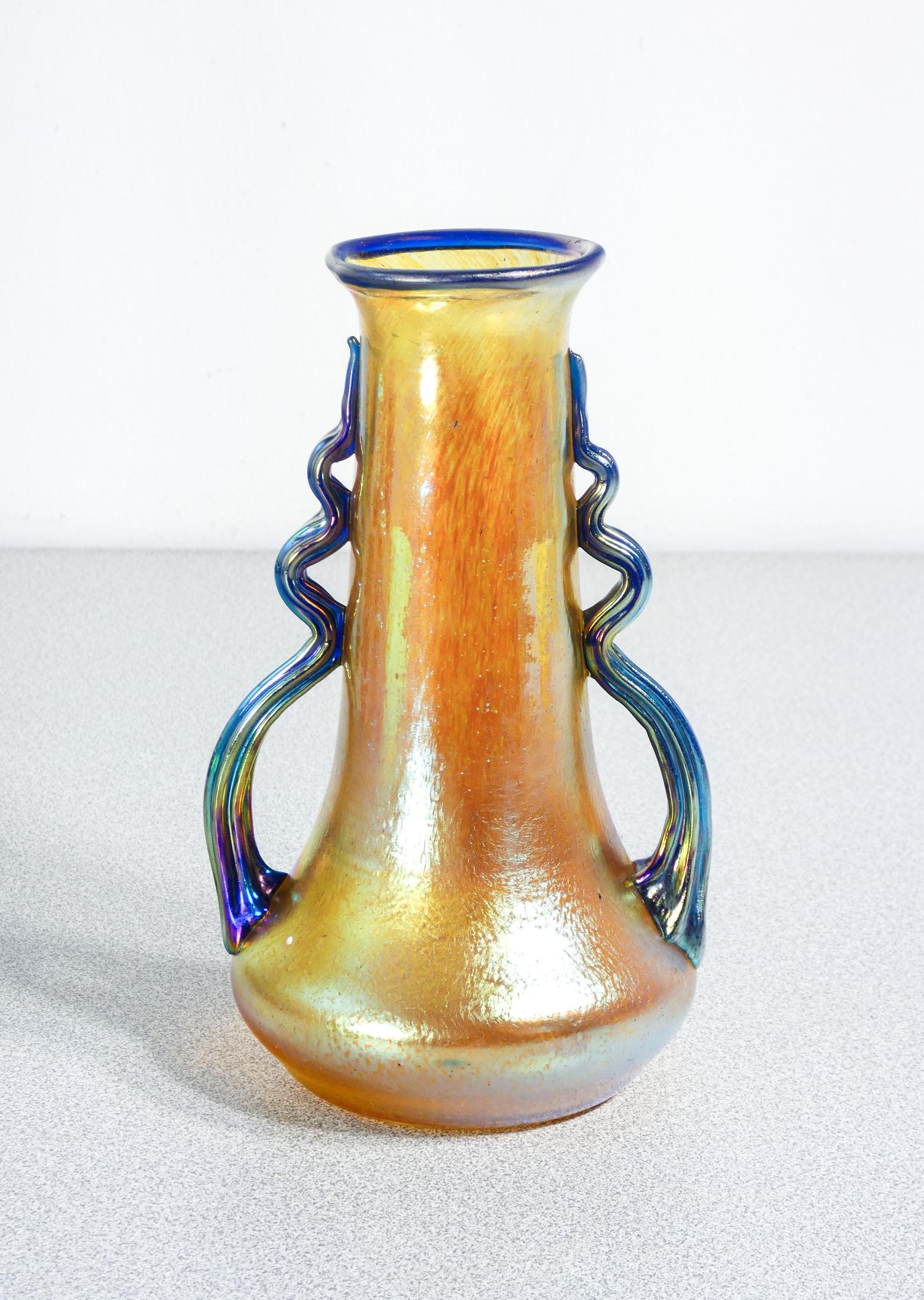 Vase made of glass
blown iridescent
LOETZ Austria,
signed on the bottom.

ORIGIN
Klostermühle

PERIOD
Late 19th century,
Early twentieth century

MARK
LOETZ
one of the most celebrated art glass factories in history, famous for its Art Nouveau-style