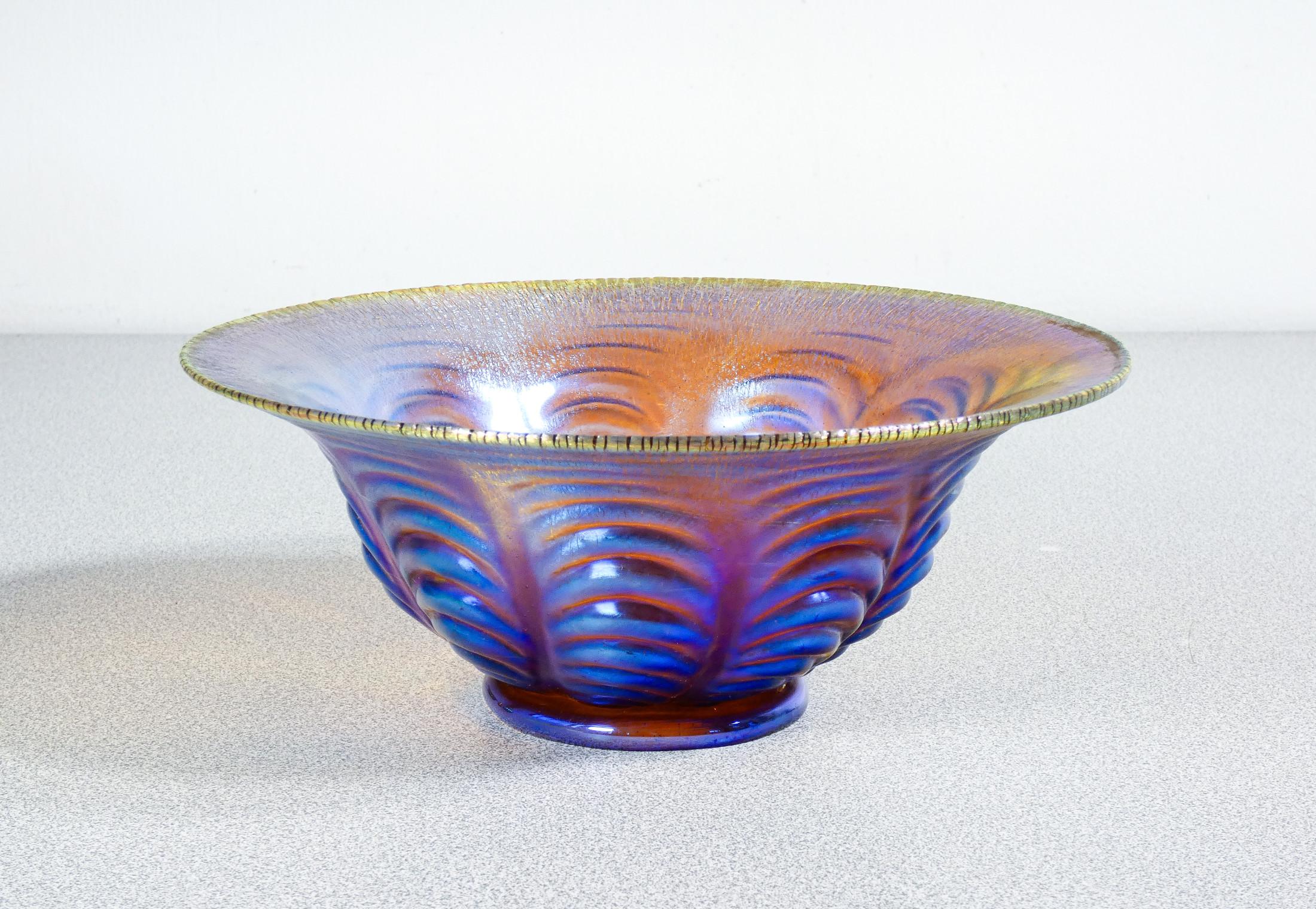 Vase, glass bowl
blown iridescent
WMF Myra series.

ORIGIN
Germany

PERIOD
Years 20/30

MARK
WMF

MODEL
Myra Series

MATERIALS
Iridescent blown glass

DIMENSIONS
Height: 8 cm
Ø 20 cm

CONDITIONS
The pot is in excellent condition, as can be seen from