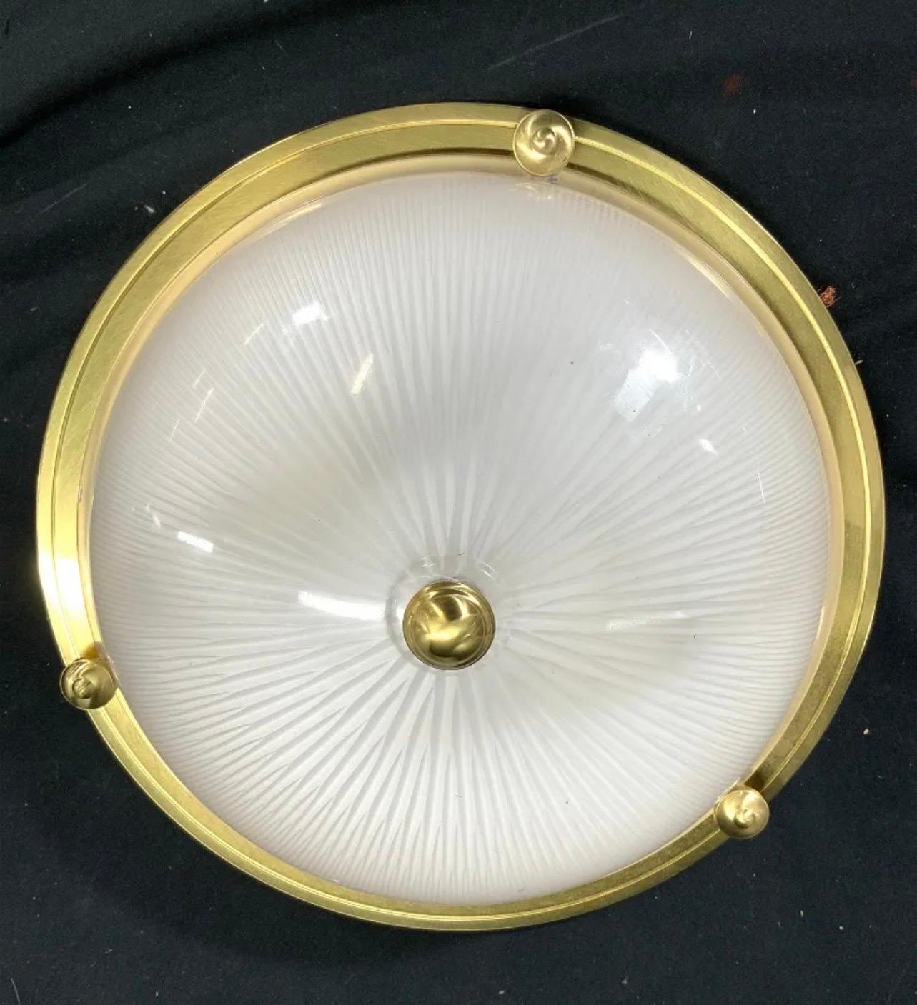 A Wonderful Pair Of Vaughan Regency Style Bronze / Brass Flush Mount Ceiling Lights Mounted With Cut Sunburst Detail To Matte Finish Glass Bowls. Each Fixture Uses Two Candelabra Bulbs. 
Price Is Per Fixture And Can Be Purchased Individually.