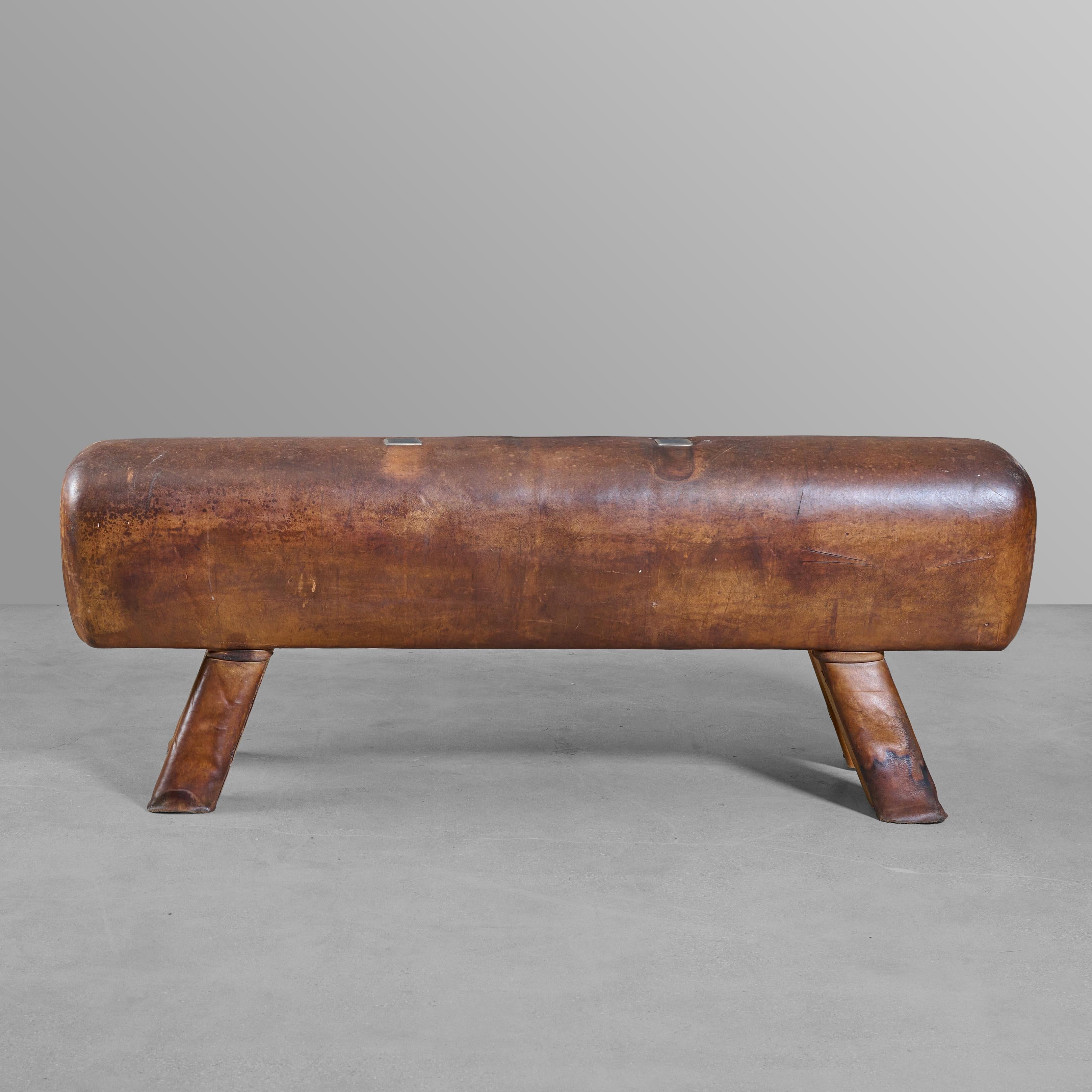 Wood, leather, and iron vaulting horse bench. With nice leather covered legs.