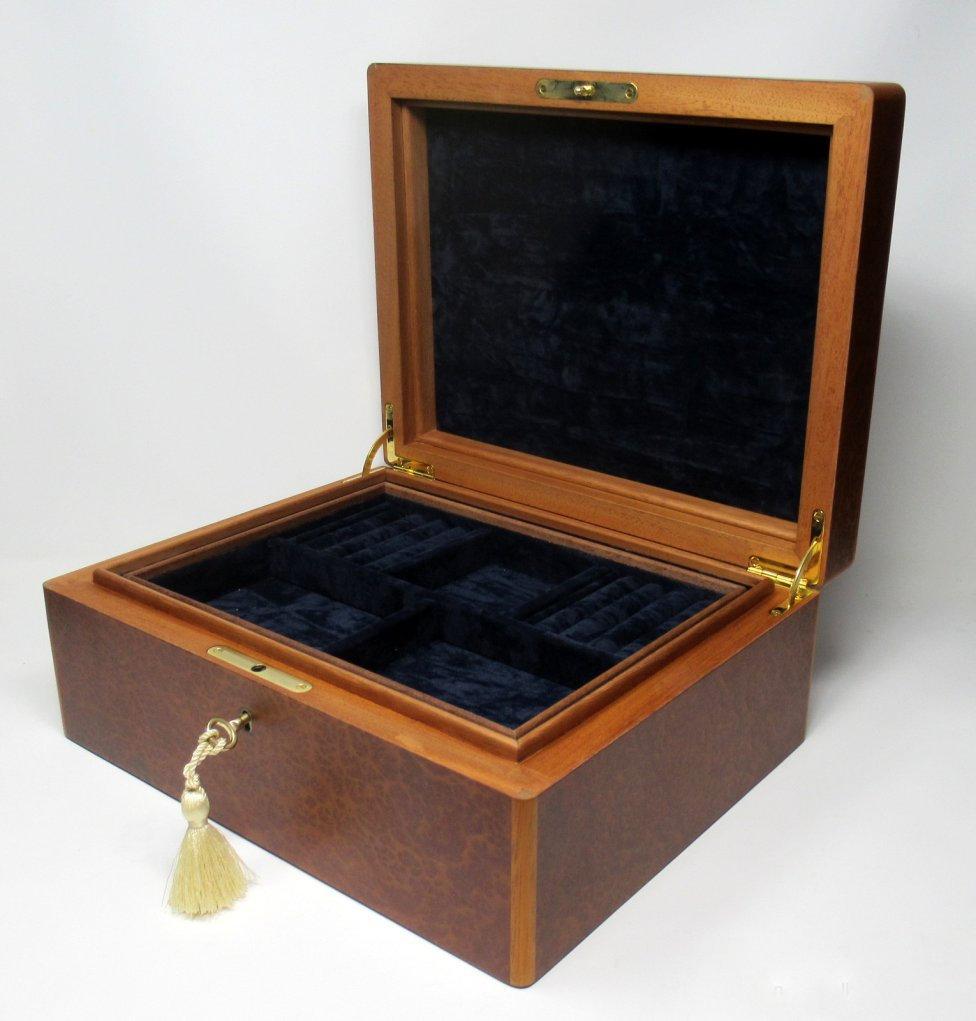 This Vavona wood jewelry casket was manufactured by the Famed Manning of Ireland Company and is truly a Jewel of handcrafted genius. This box is constructed of the finest woods available and the knowledge and skill of 4 generations of box making in