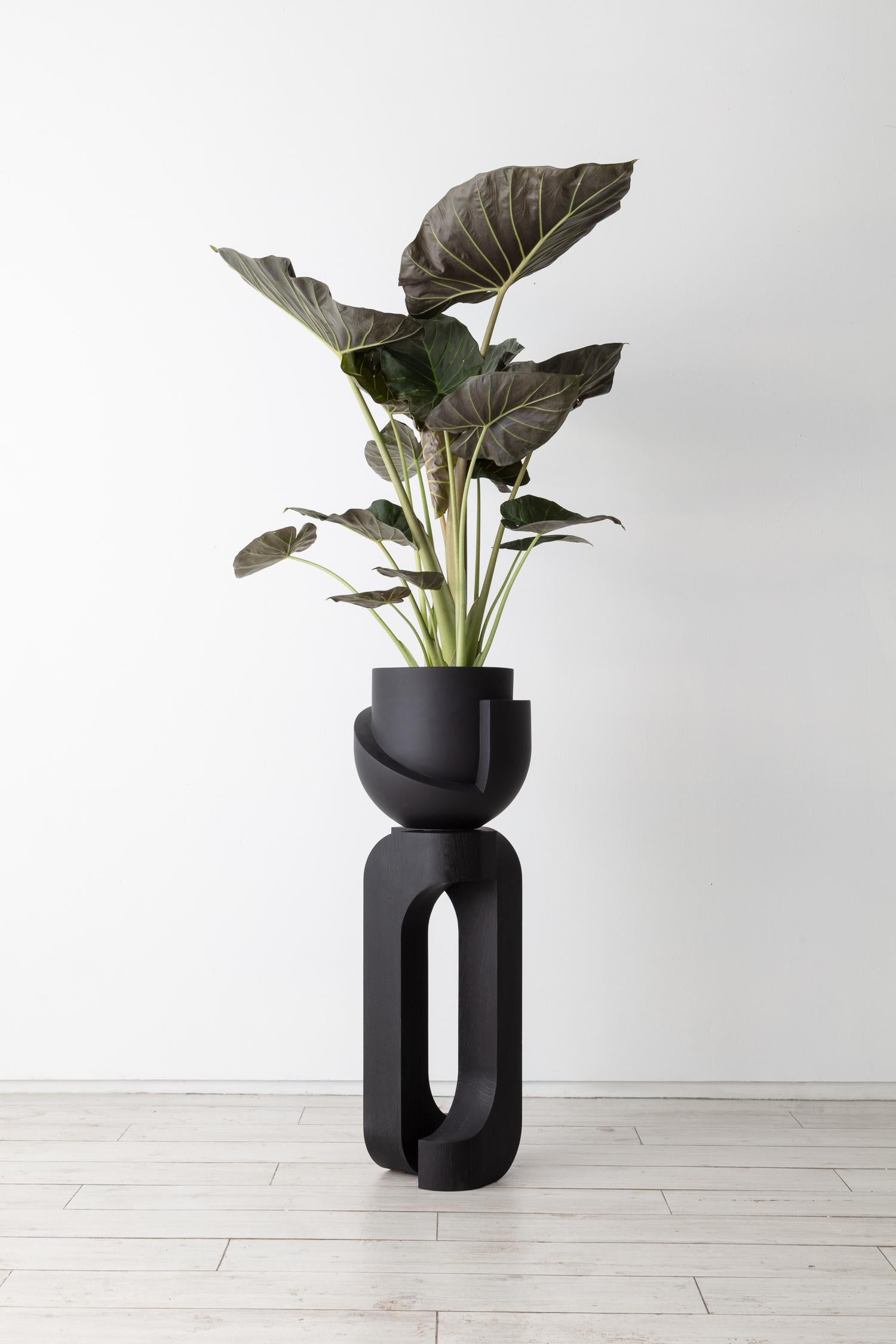 Vayu Coal with Sculptural Pedestal.

Solid oak plant stand handmade in Brooklyn by Joel Seigle, paired with our Coal Vayu Planter.

Materials: Vessel earthenware, base solid oak

Each stand is made to order, please allow 8-12 weeks for