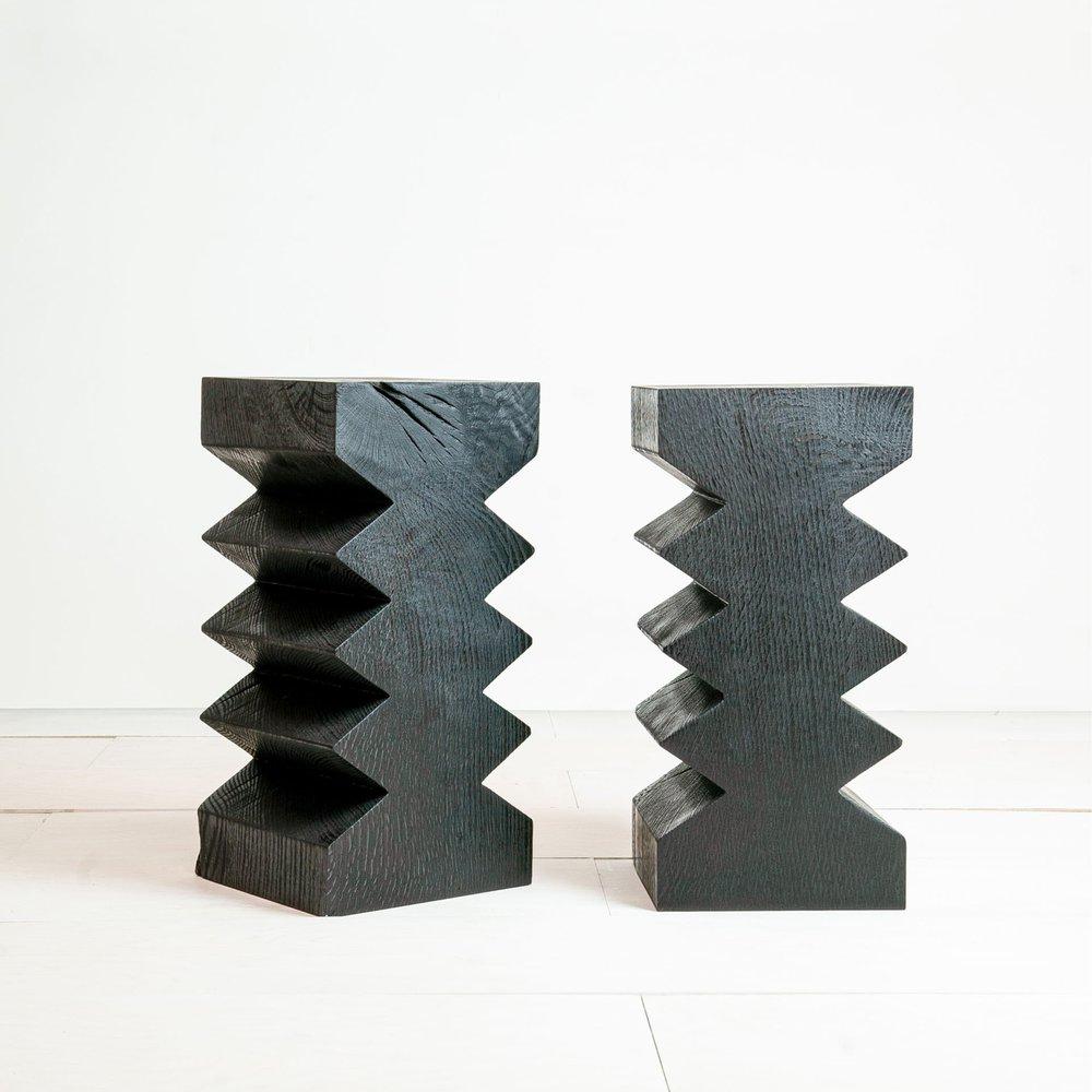 Vayu Side Table by Mythology
Dimensions: D 25 x W 25 x H 50 cm
Materials: Scorched reclaimed oak.

Sculpted from a single piece of reclaimed timber and scorched to a deep black, the Vayu side table presents a dramatic form.
Cracks in the wood,
