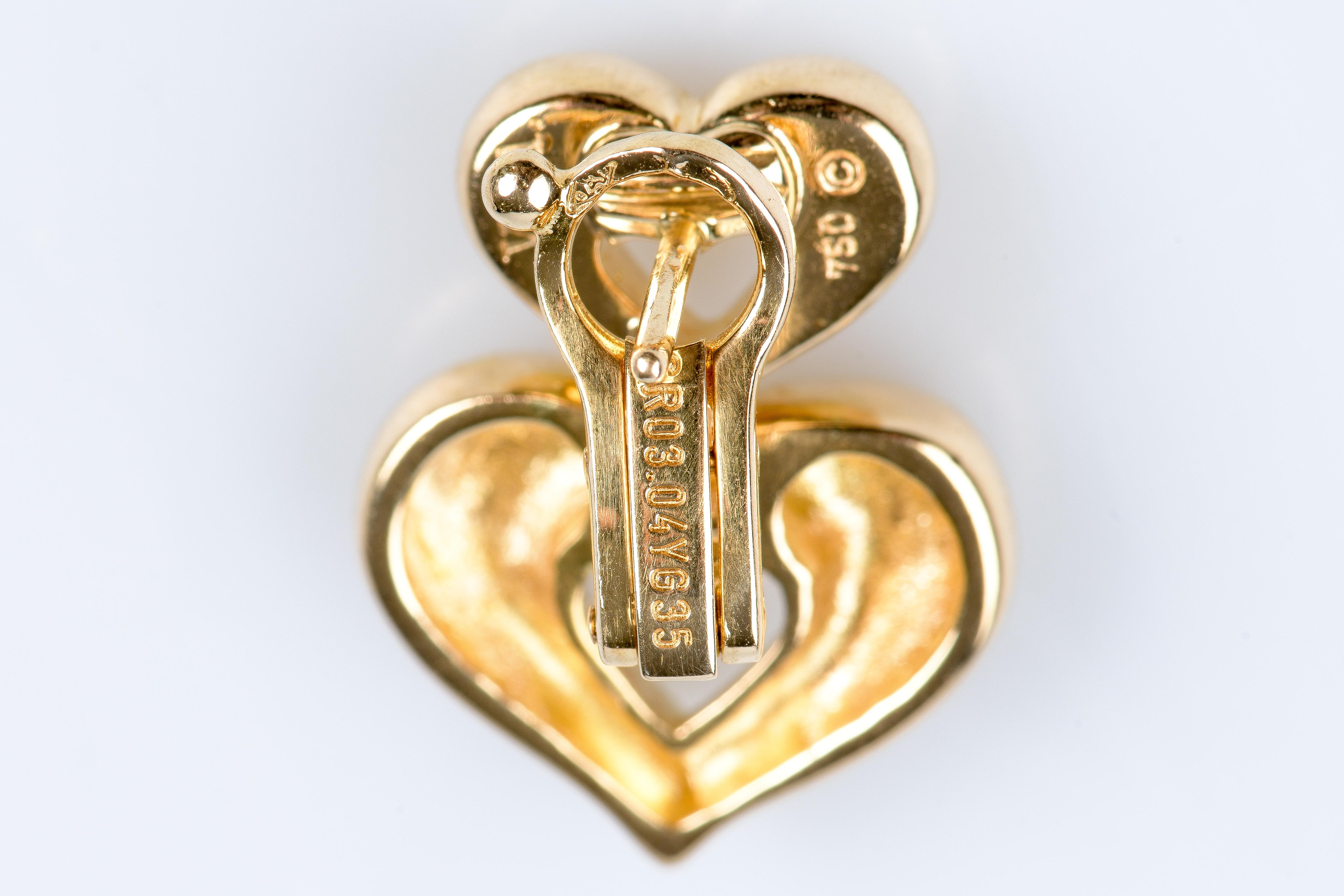 VCA Heart Shaped Earrings in 18K Gold. Each earring has two smooth, polished hearts with rounded edges. The second heart hangs on the first adding an extra touch of romance to this already charming jewel. 

Weight: 16.70 gr. 

Dimensions: 1.6cm x