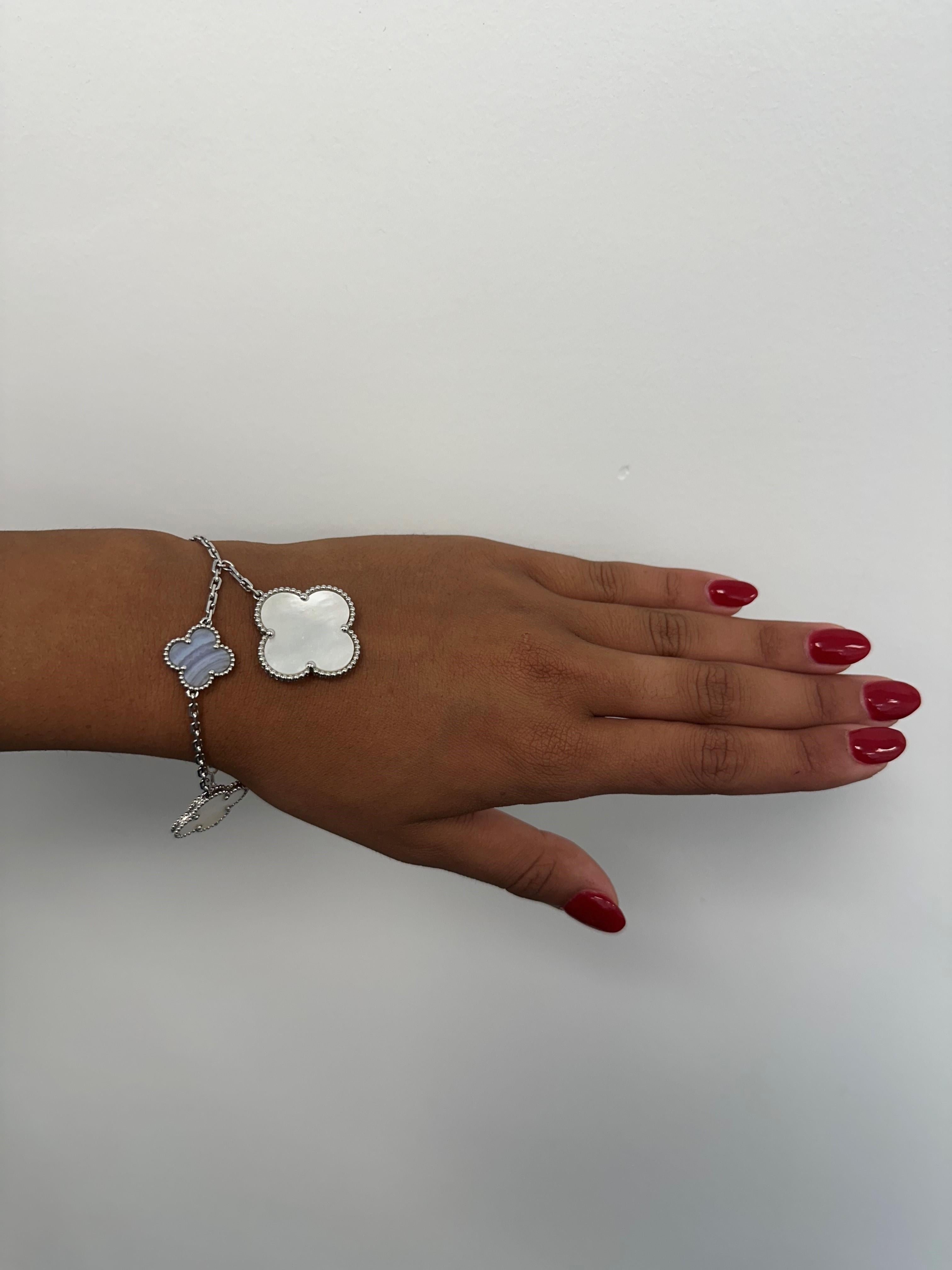 The Van Cleef & Arpels Magic Alhambra Bracelet in white gold features a beautiful mix of chalcedony and mother-of-pearl. Its iconic Alhambra motifs blend the soft blue of chalcedony with the shimmering white of mother-of-pearl, creating a chic