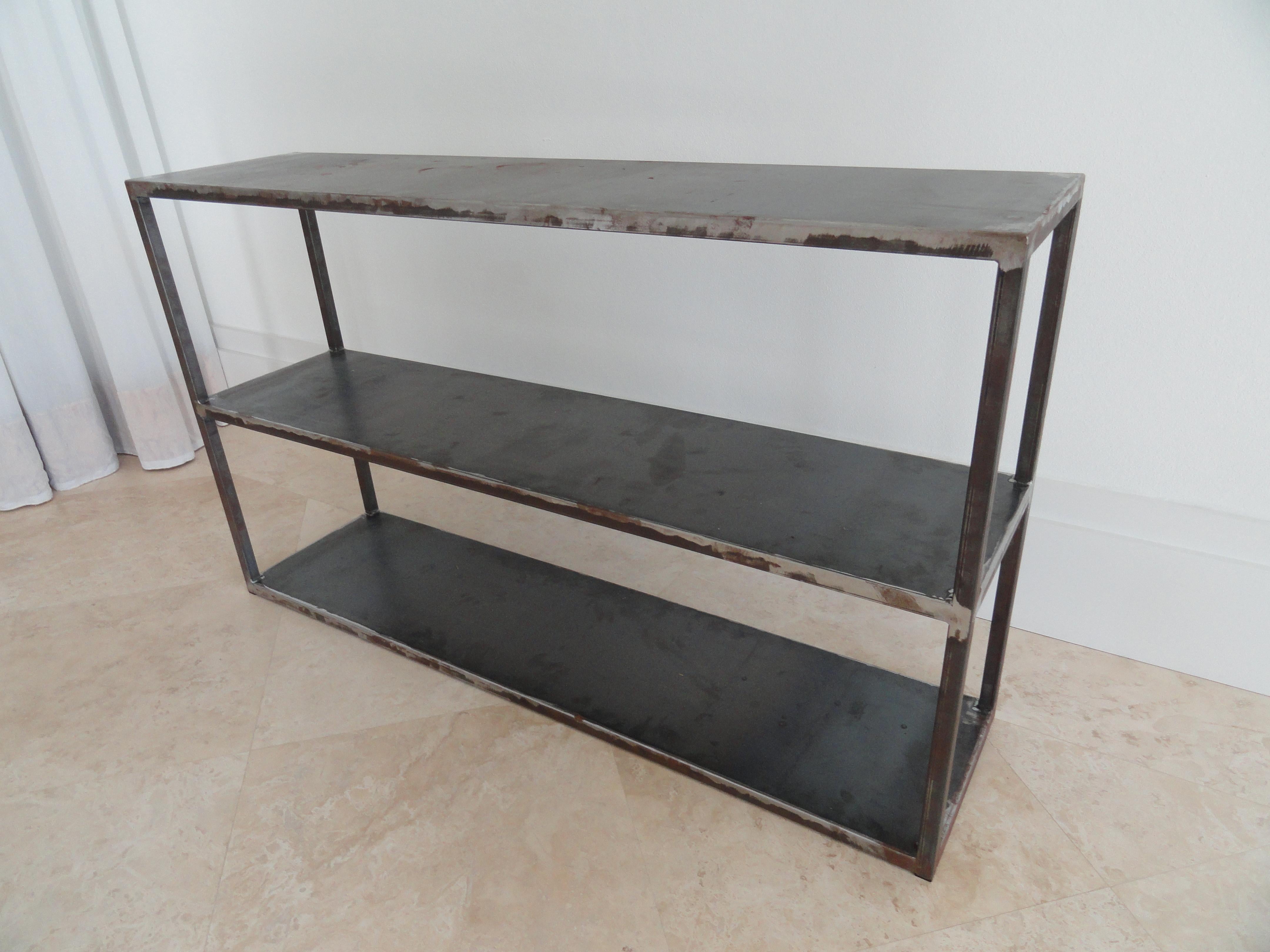 This reproduction table of an original by Van Day Truex follows the style, shape and form of the original. Produces in natural metal.
Custom dimensions and enamel colors available.
Three tiers with corner uprights.
Custom size and finishes prices