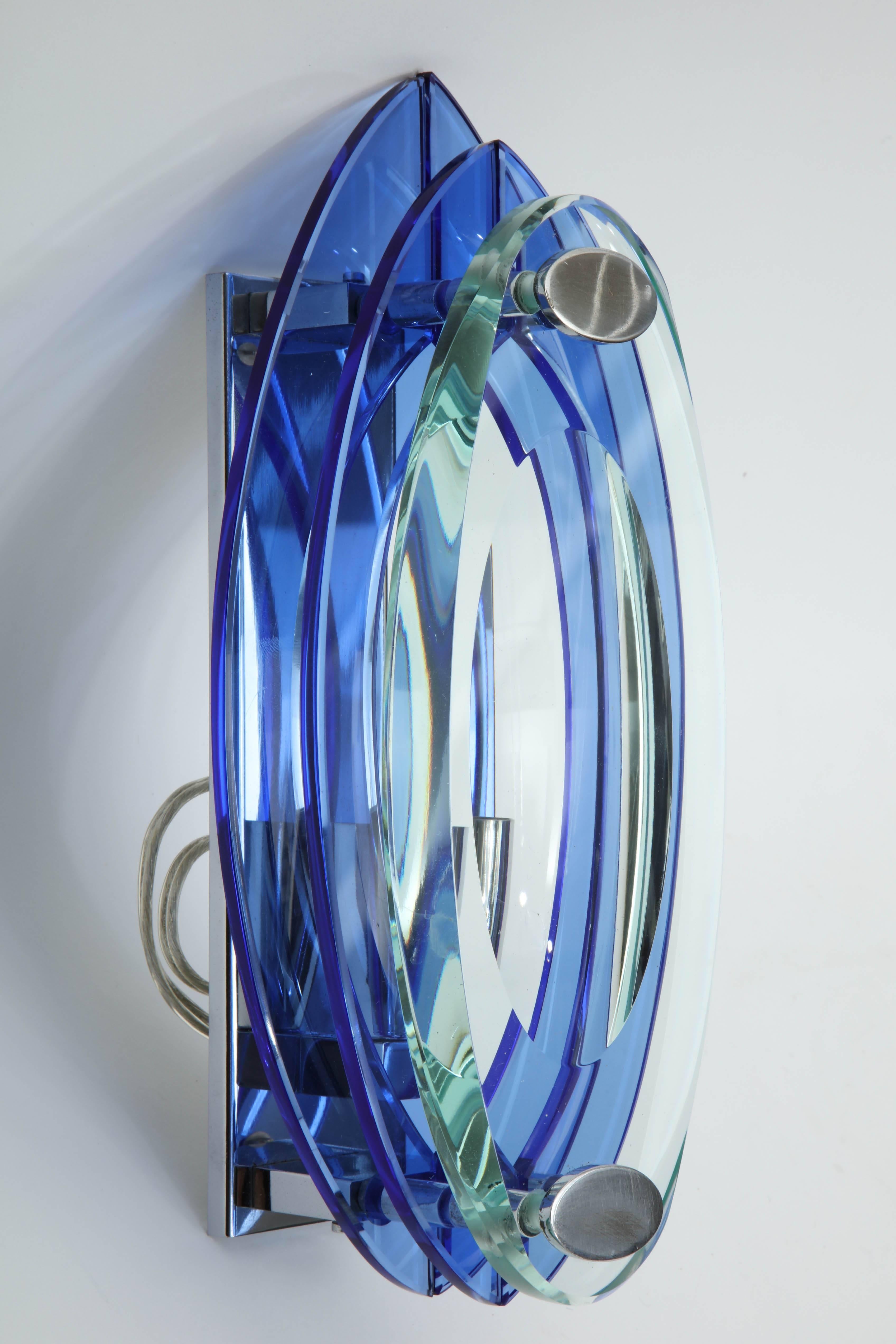 Pair of elliptical shaped Murano glass sconces composed from layers of blue and clear glass on chrome frame. Each sconce has one-light source, 60W Max. Rewired for use in the USA.