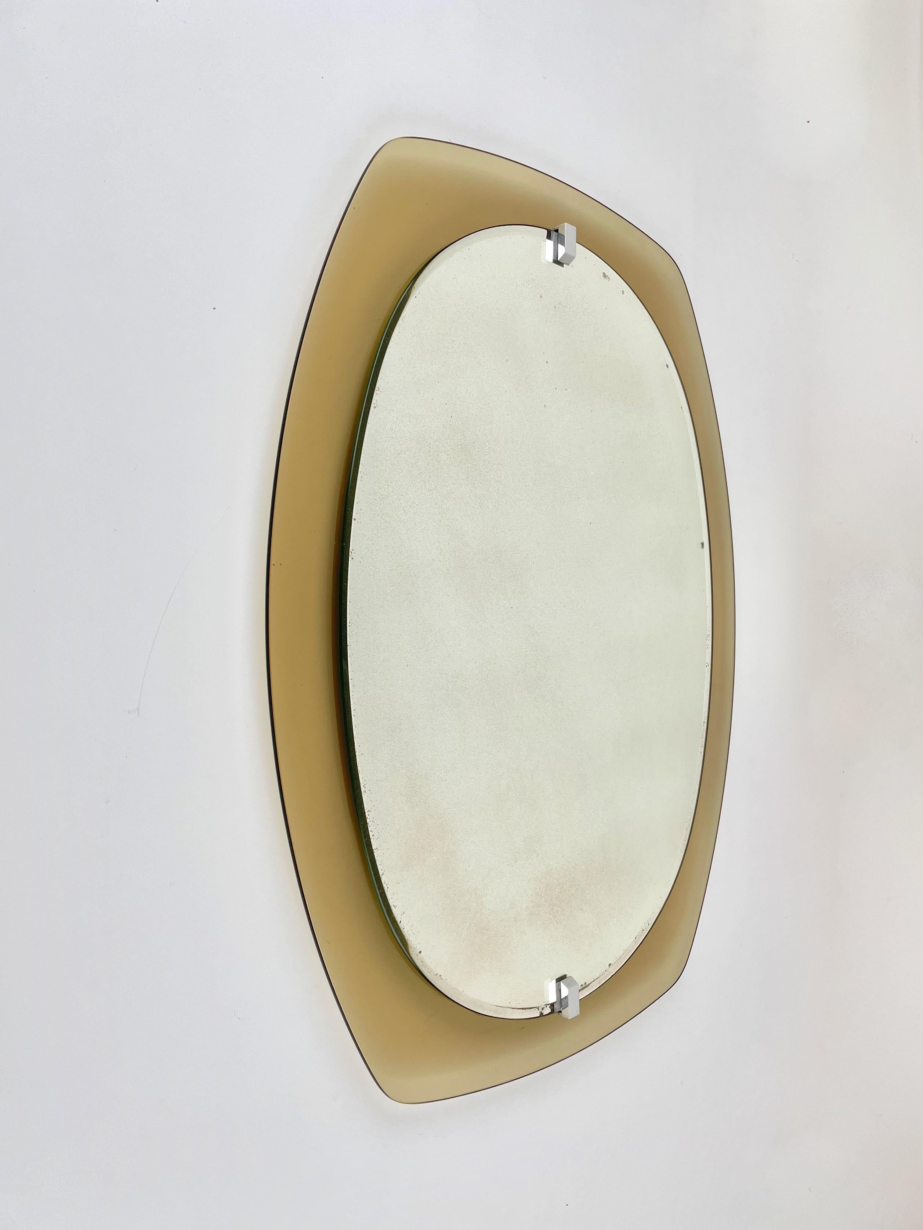 Mid-Century Modern wall mirror by Veca in smoked glass with chrome details. Made in Italy in the 1970s. 
It has its original foil label still attached on the back.
