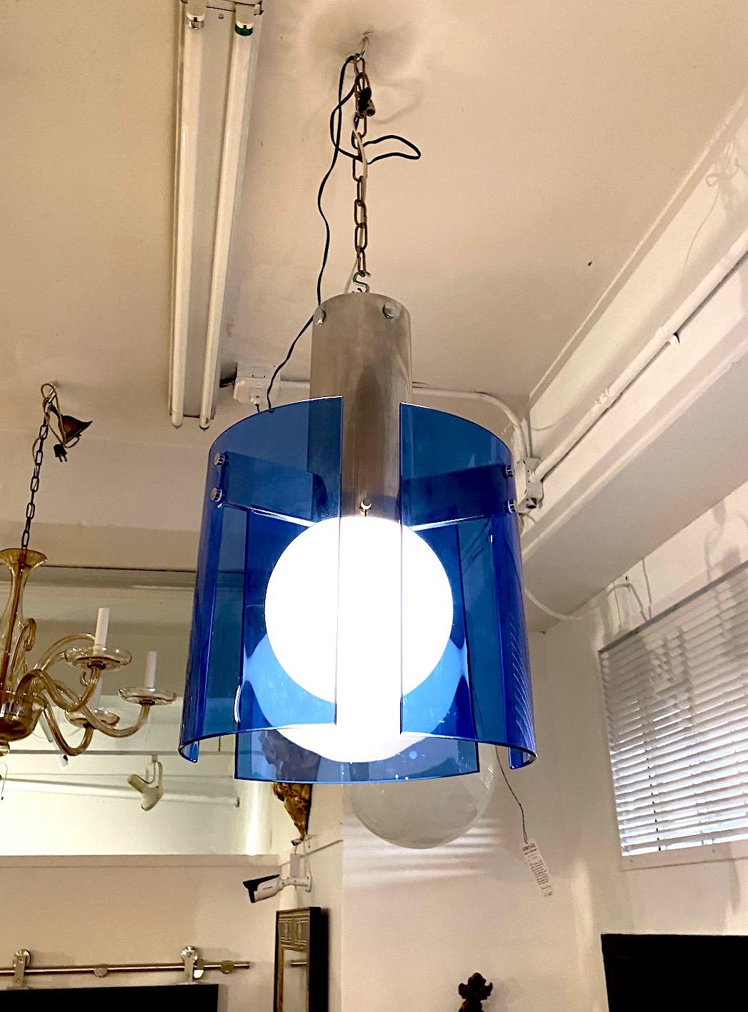 An elegantly designed 1970s ceiling mount pendant light by Italian lighting company Veca. Three hand formed cobalt blue glass panels attach to the central chrome column by three rectangular chrome arms. The light may be mounted directly onto the