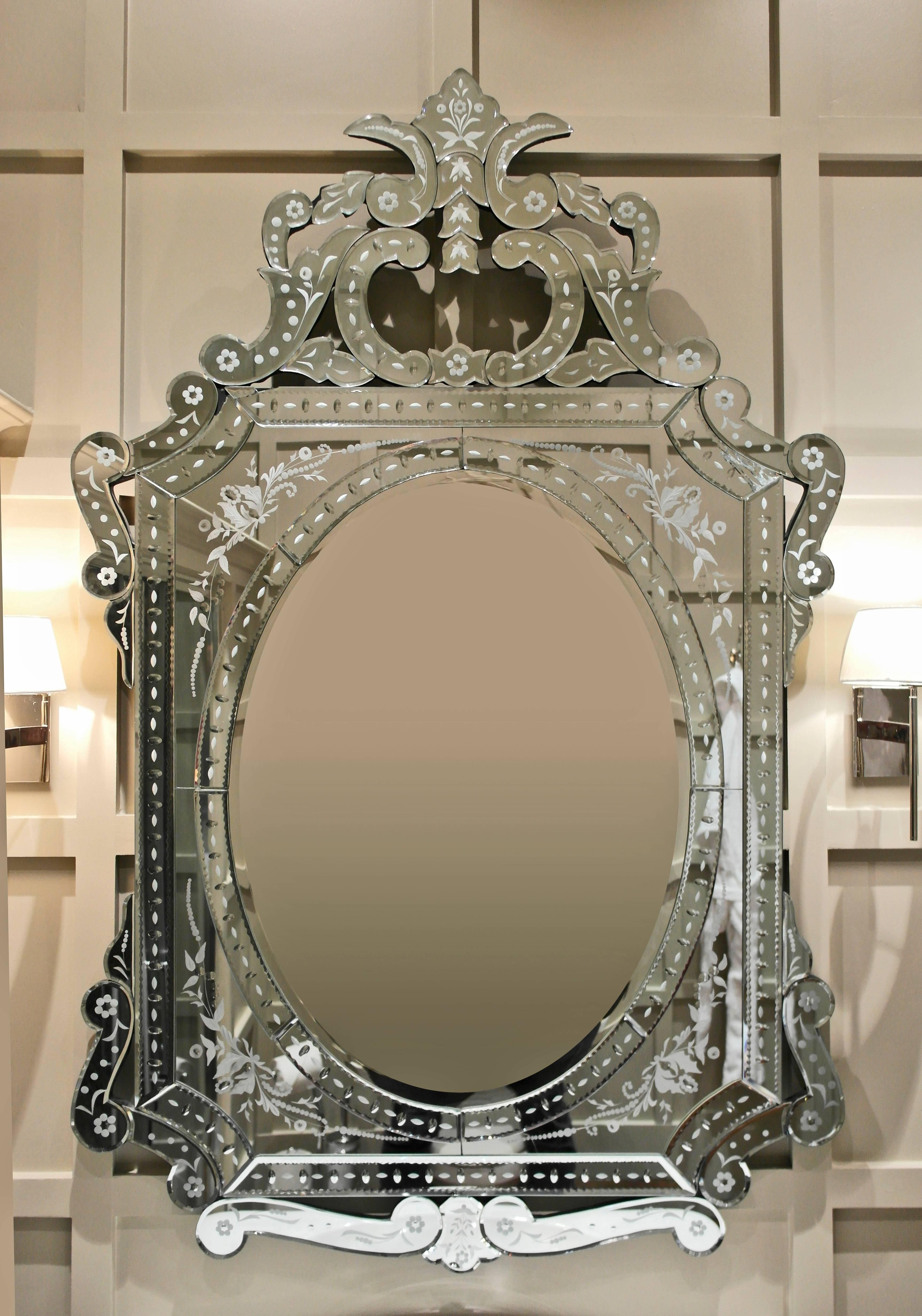 Large rectangular mirror framed with ribbon scroll design featuring etched florettes.