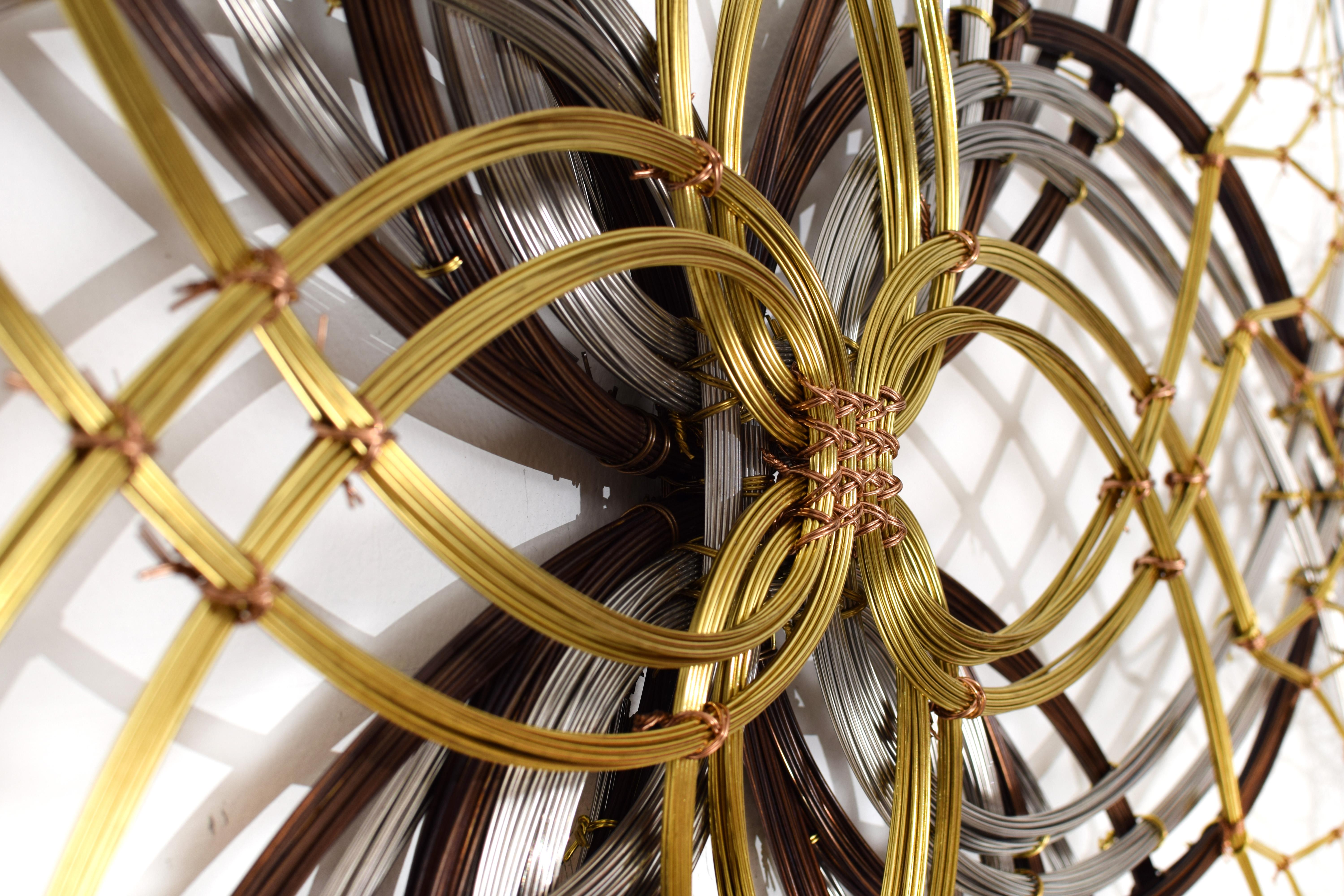Aged bronze, brass, stainless steel. 

Kue King created this mandala inspired sculpture using bronze, brass, and stainless steel wire. The bronze is aged to give the sculpture a warmth and depth in color and display. The polished stainless steel