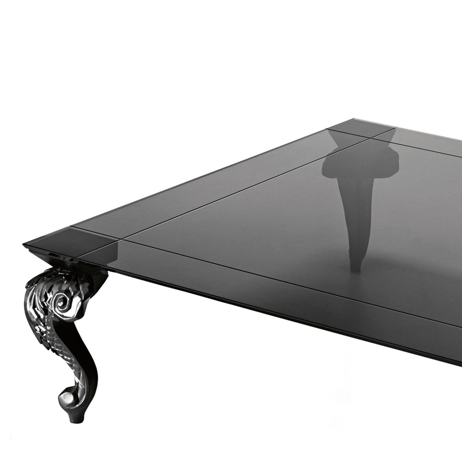 Coffee table Vega with engraved and bevelled
 top in tempered smoked glass, 12mm thickness.
With 4 casted resin feet, in black painting finish.
Also available in:
L 130x D 130 x H 40cm, price: 6900,00€
L 160x D 100x H 40cm, price: 6500,00€.