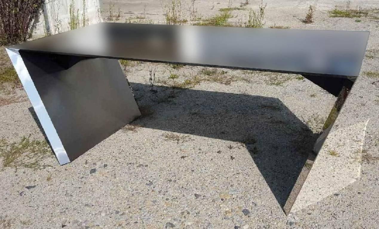 This visionary stainless steel Vega desk is an archetype of simplicity. Includes the two-drawer storage unit in brown leather and stainless peninsula. The tops and interior sides are polished to a satin finish, while all other parts are polished to