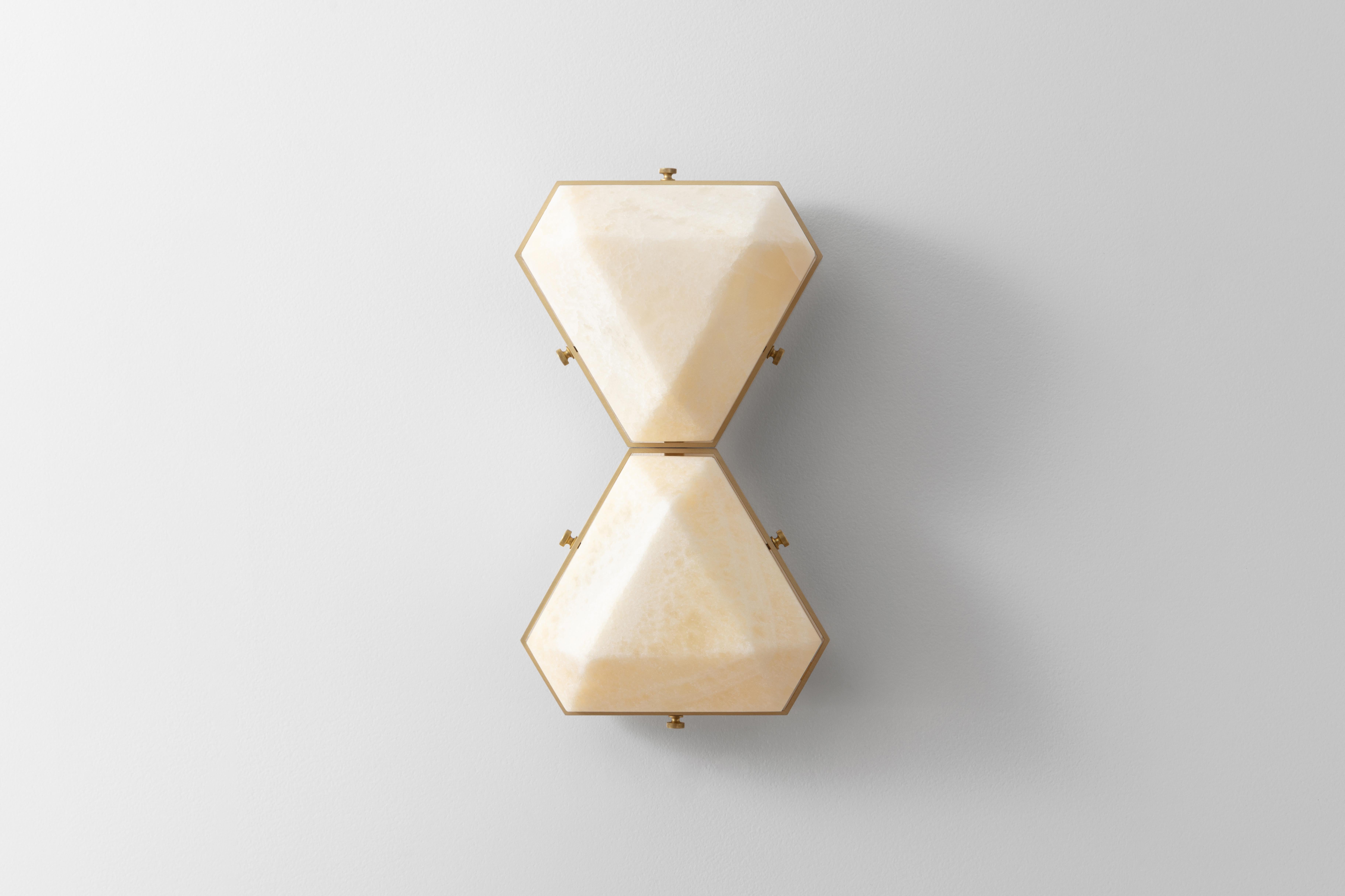 The Vega Due is a geometric, modular, contemporary lighting fixture. Vega is suitable for installation on the ceiling as a flush mount, or on the wall as a sconce. The body is made from extruded aluminum with brass accents. The diffusers are carved