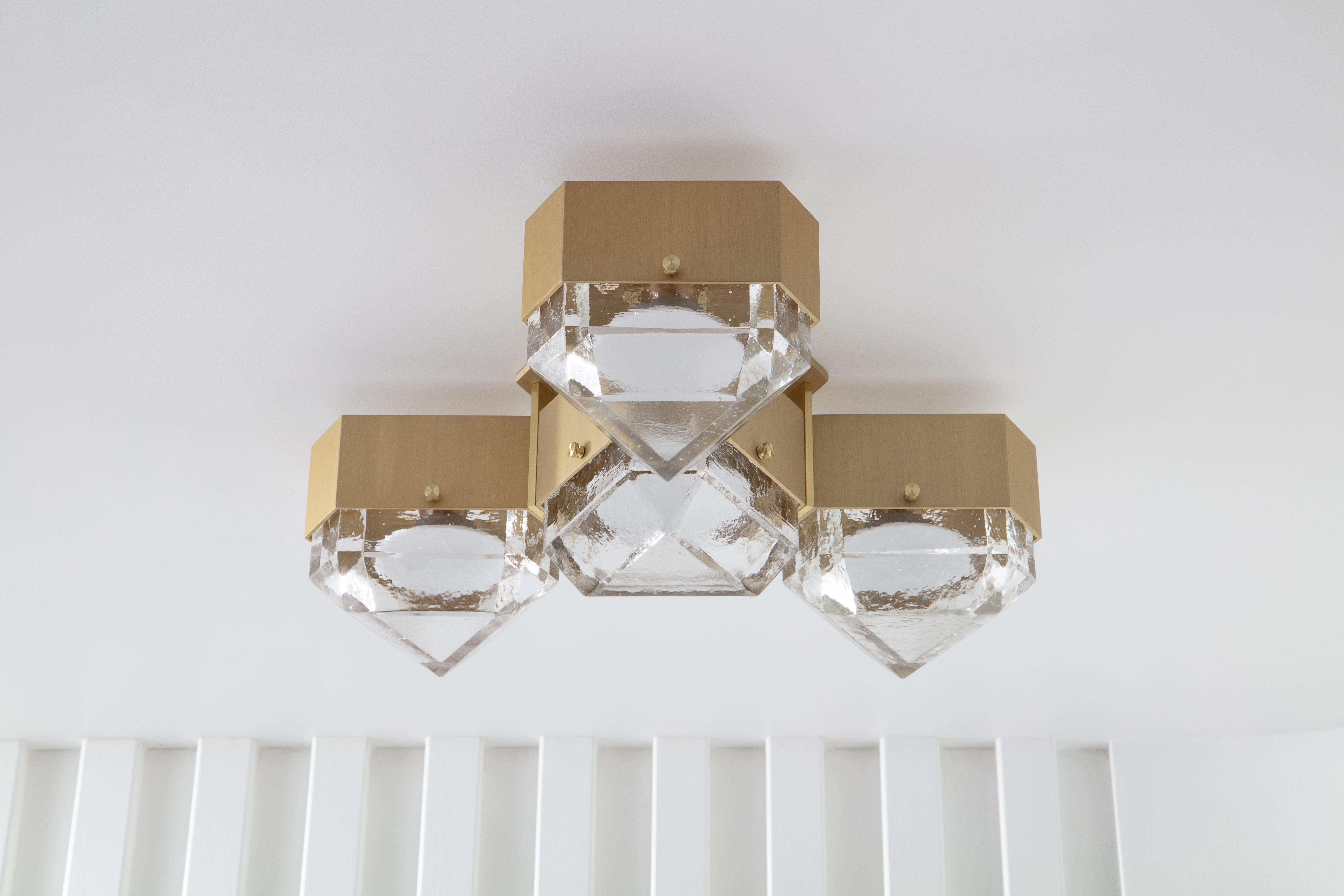 Vega is a geometric, modular, contemporary lighting fixture. The body is made from extruded aluminum with brass accents. The diffusers are available in cast glass. No external driver is necessary since Vega is outfitted with fully dimmable, warm