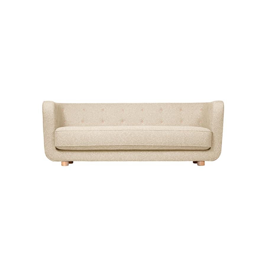 Vegeta buttons and natural oak signatur Model Vilhelm sofa by Lassen
Dimensions: W 217 x D 88 x H 80 cm 
Materials: Textile, Oak.

Vilhelm is a beautiful padded three-seater sofa designed by Flemming Lassen in 1935. A sofa must be able to