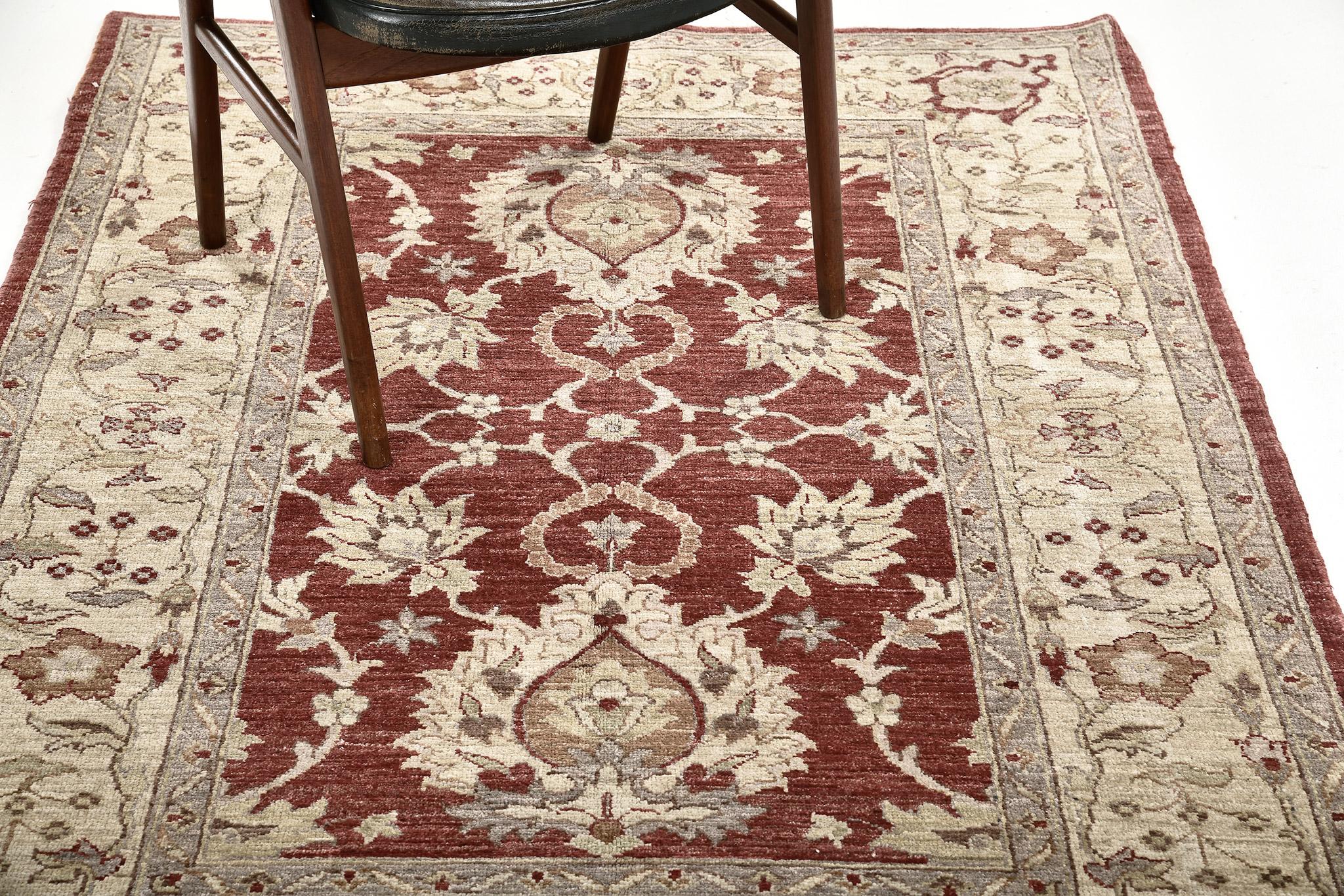 A vibrant Sultanabad Design rug in Divine Collection that beguiles you to an all-over pattern of botanical elements unified in creating this magnificent piece. The abrashed ruby field is covered by majestic patterns of blooming palmettes, alluring