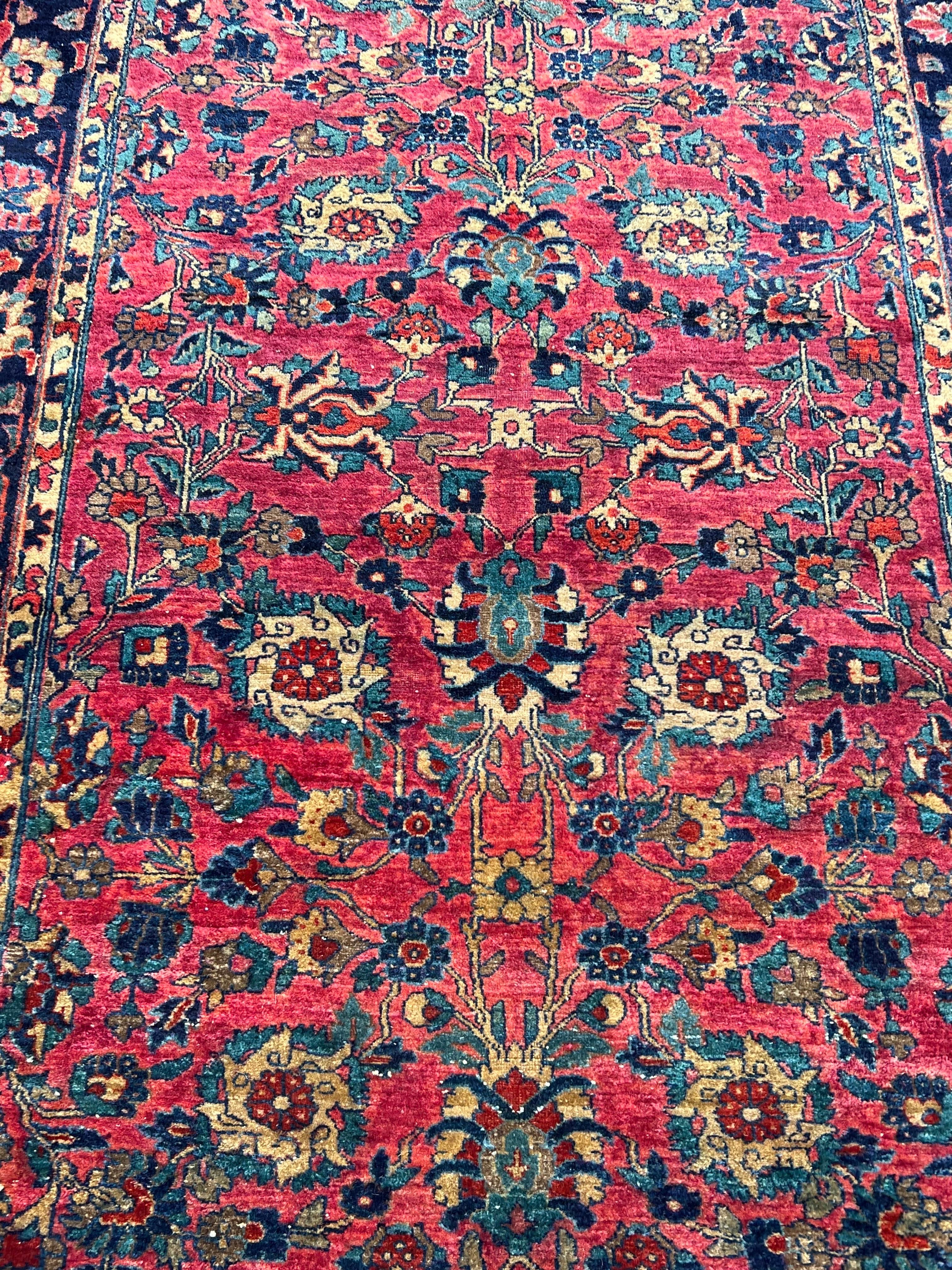 Vegetable Dyed Mid 20th Century Persian Rug. Gorgeous cranberry and cobalt colors with decorative medallion and floral border. Fringe is missing on edges. Hand woven wool.