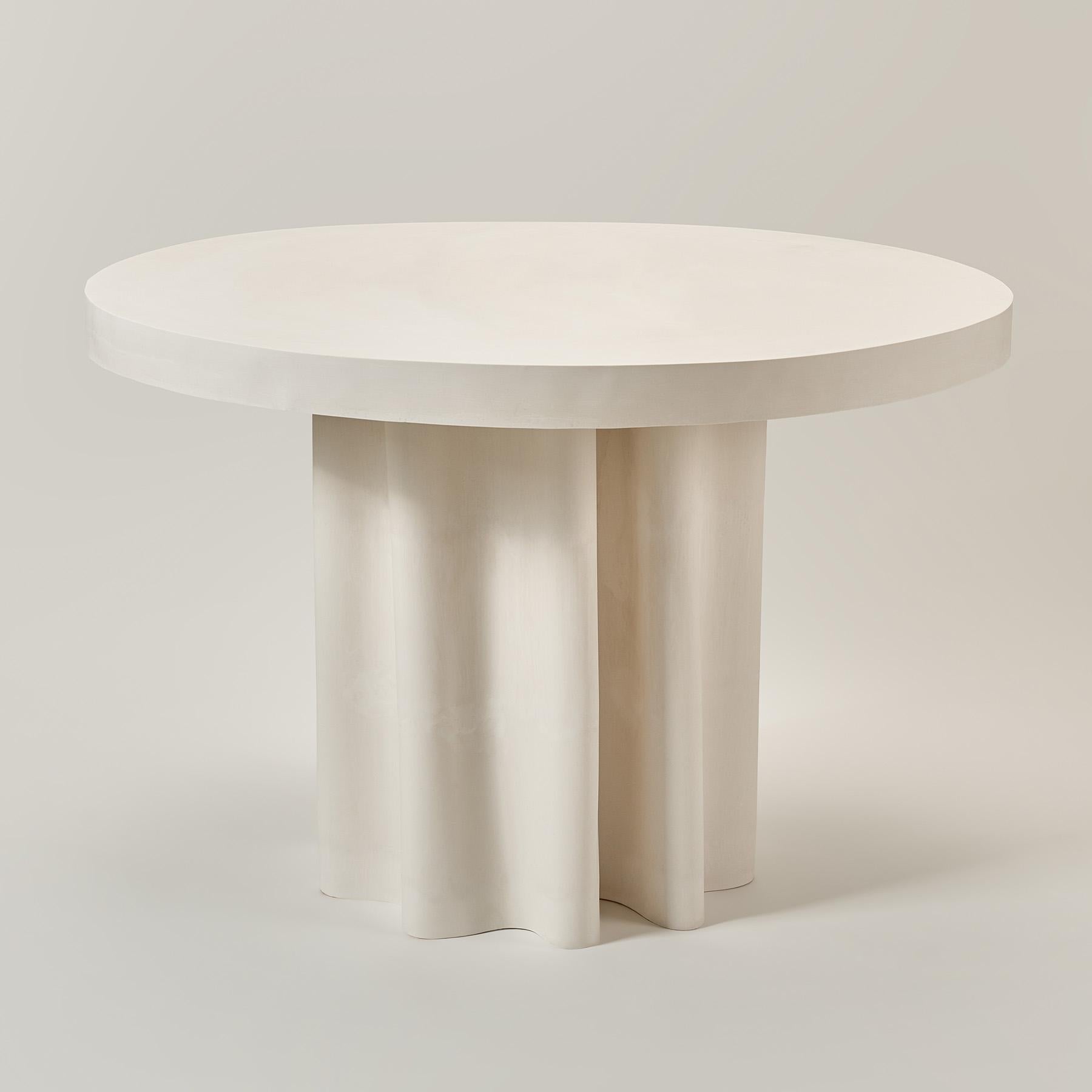 Veil Round Dining Table by Perler
Limited Edition
Dimensions: D 120 x H 76 cm, Top thickness: 7 cm, Leg Ø: ≈ 60 cm
Materials: Jesmonite.
Weight: 80 kg.
Seats: 4-6

Color: A subtle shade of warm white/ivory
Finish: Matte
Texture: Smooth to the touch,