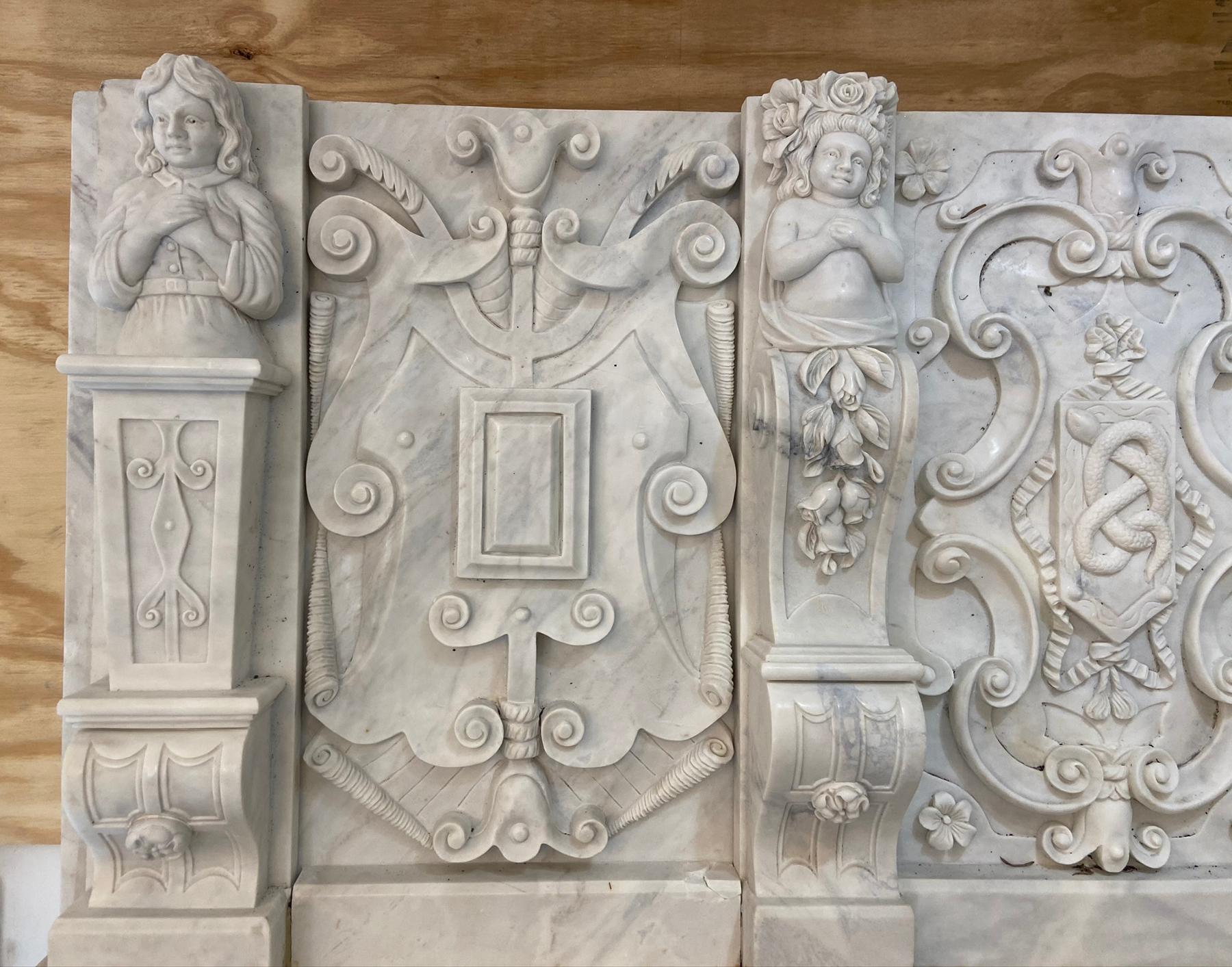 About nine feet tall a beautifully carved marble mantle piece. Very nicely veined Italian marble. This is truly impressive mantle that is meant to be built in. approximately 86 inches wide by 119 inches tall the opening is 40 wide by 36 inches high.