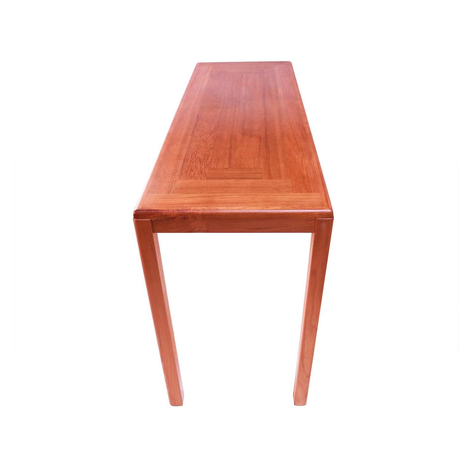 A handsome, sleek Danish modern teak console, sofa table, by Vejle Stole Møbelfabrik. Features a geometric parquet design on the rectangular table top showcasing the teak grain. Finely constructed with rounded edges, the legs slightly protrude from