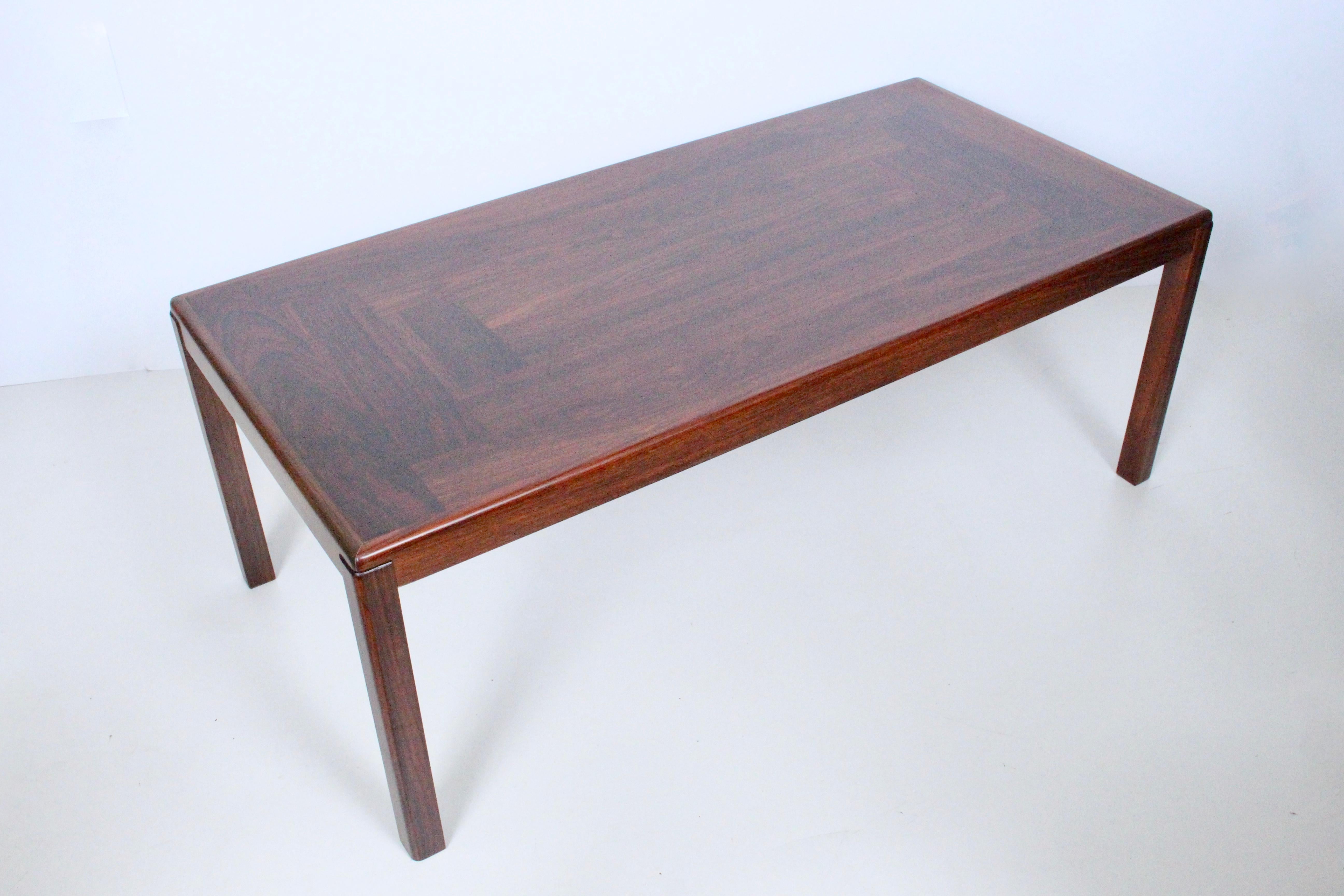 Danish Modern Vejle Stole Og Mobelfabrik rosewood coffee cocktail table. Featuring a rectangular beautiful, darkly grained reinforced Rosewood framework with solid Rosewood sides and legs. Stamped to underside, Vejle Stole og Mobelfabrik, Made in