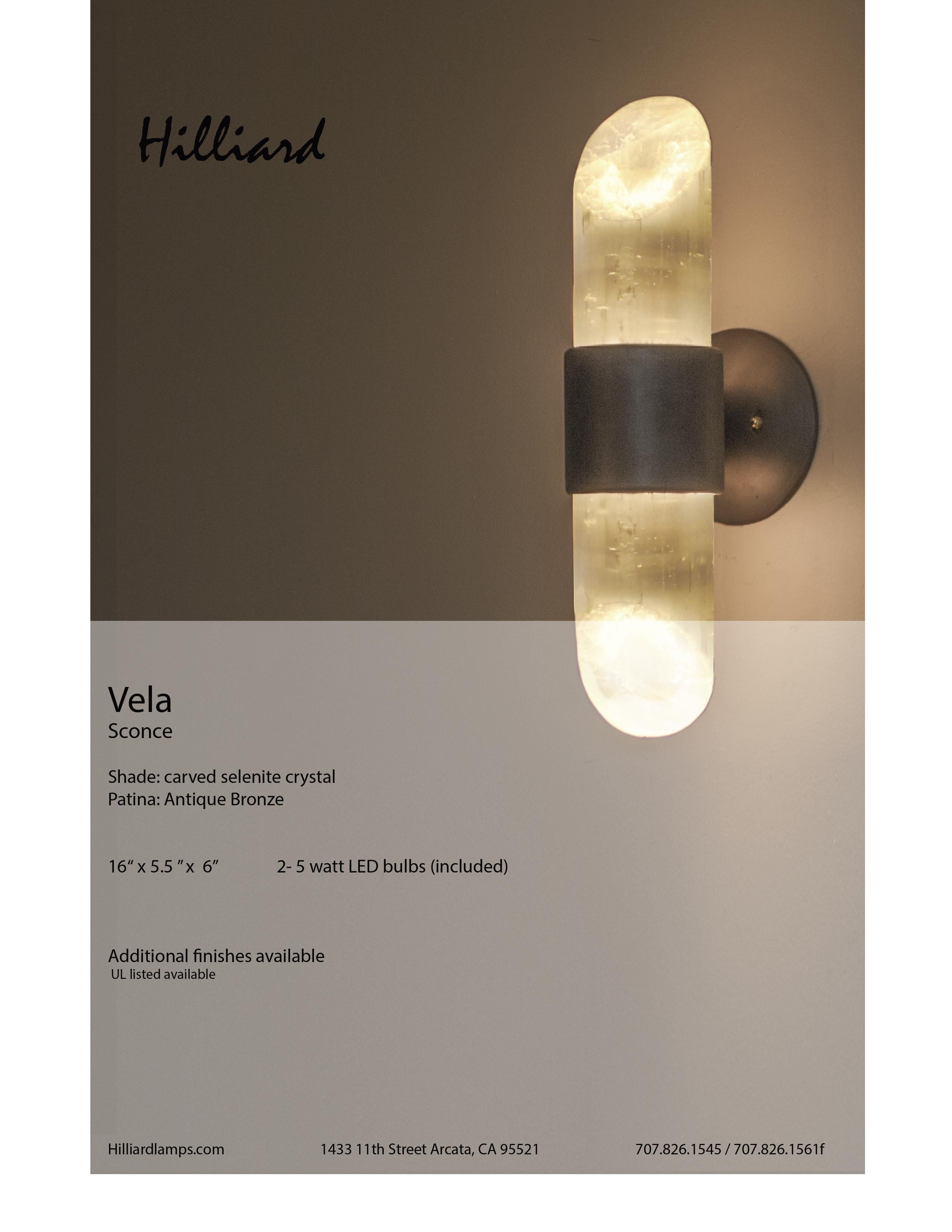 The Vela sconce is part of our hand carved LED Crystal Collection.
Featuring polished selenite that has that special reflective glow and a sand cast bronze frame
Designed by Samuel Hilliard 2016
Measures: 16“ x 5.5 ”x 6”
2- 5 watt LED bulbs