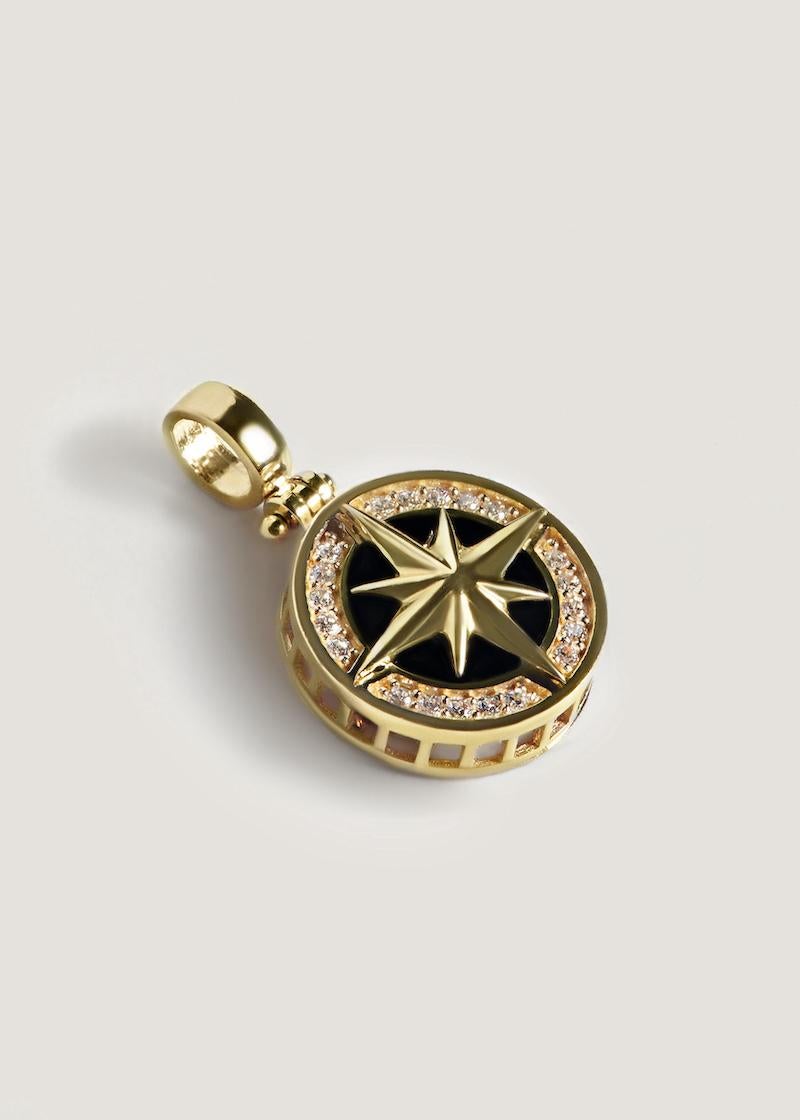 This pendant features a gold north star on an onyx backdrop, bordered by diamond stones.

Features 20 round cubic zirconia or diamond stones.

Onyx inlay.

14k solid gold—always
Weight: Approx 4.8g
Measurements: 16mm x 25.5mm
Depth: 4.5mm
Stone 1: