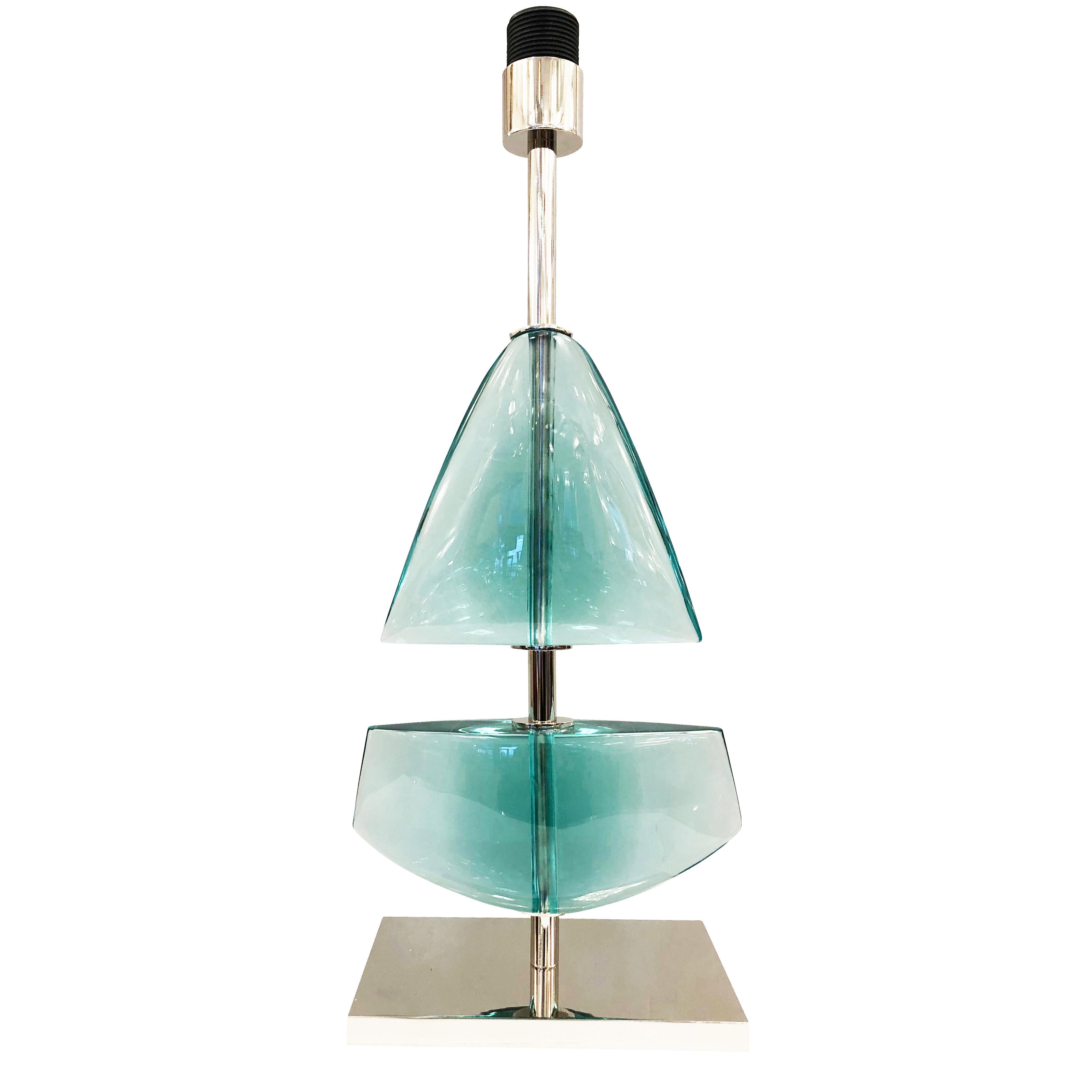 Limited edition glass table lamp made by glass artist Effetto Vetro for Gaspare Asaro’s studio line, formA. Each lamp is hand carved in two sections reminiscent of a sail boat. Available in six different colors. The stem and base are nickel but can