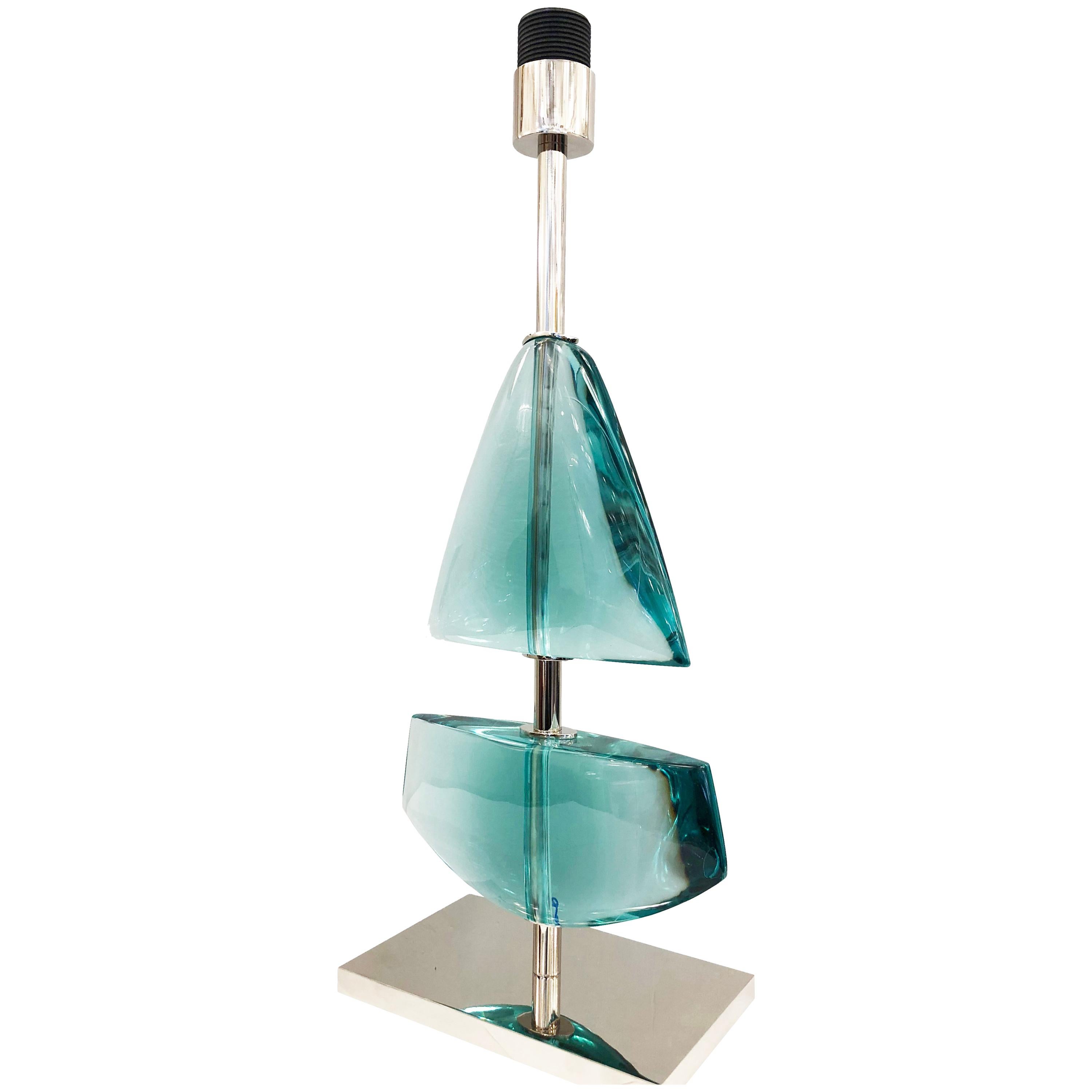 Limited edition glass table lamp made by glass artist Effetto Vetro for Gaspare Asaro’s studio line, formA. Each lamp is hand carved in two sections reminiscent of a sail boat. Available in six different colors. The stem and base are nickel but can