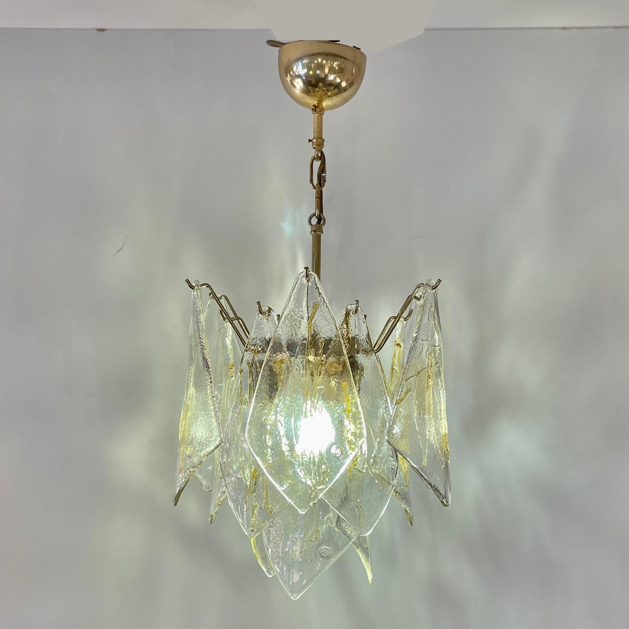 Italian chandelier with 16 diamond shaped Murano glass pieces separately hung on a brass frame. The glass pieces are created by hand according to the tradition of La Murrina and each glass piece is signed and has a unique gold/honey colored