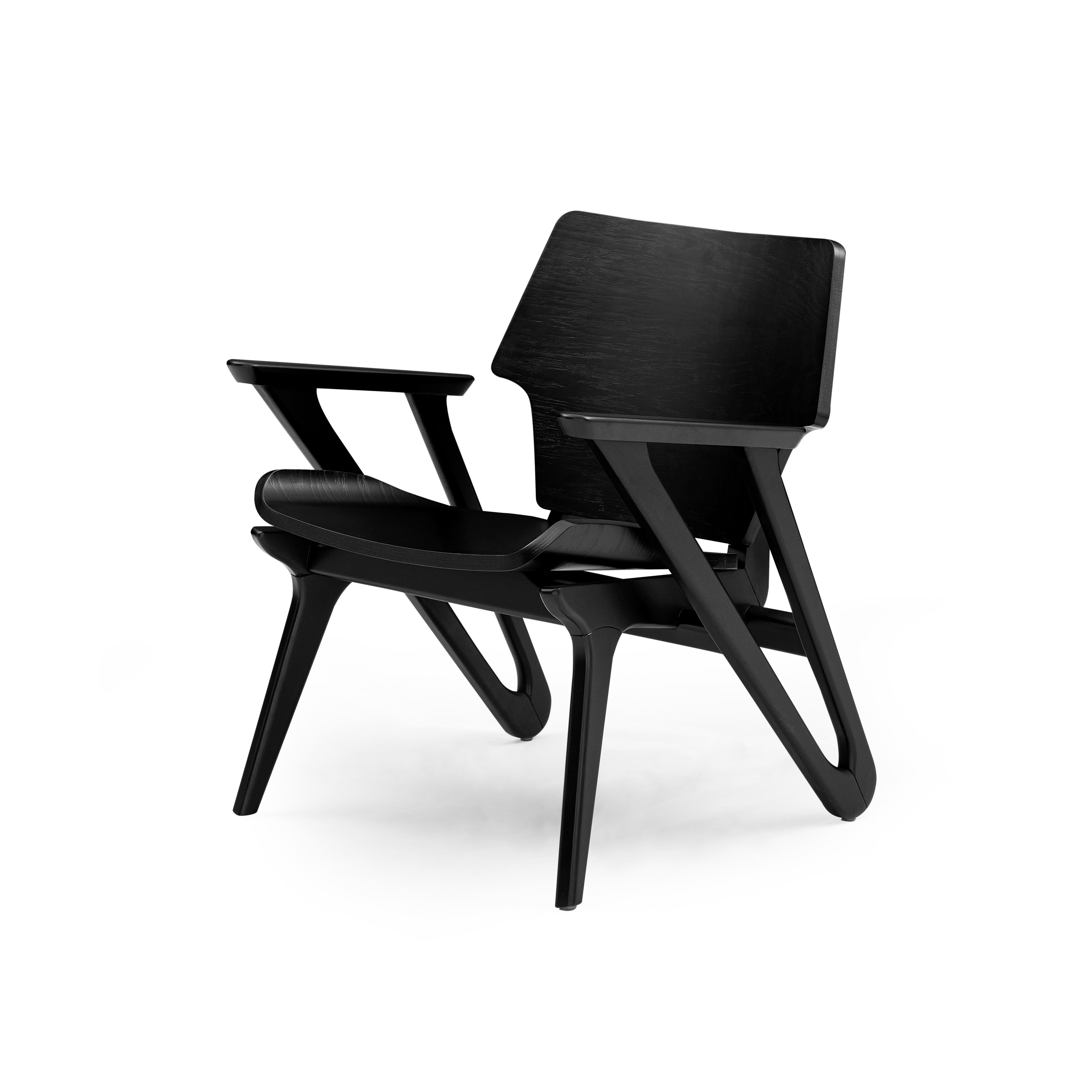 Dieser minimalistische Sessel Velo mit geformter Sitzfläche und Rückenlehne zeichnet sich durch ein einfaches und stromlinienförmiges Design aus, mit geometrischen Formen und einer geschwungenen Sitzfläche mit weichen und starken Ecken, die