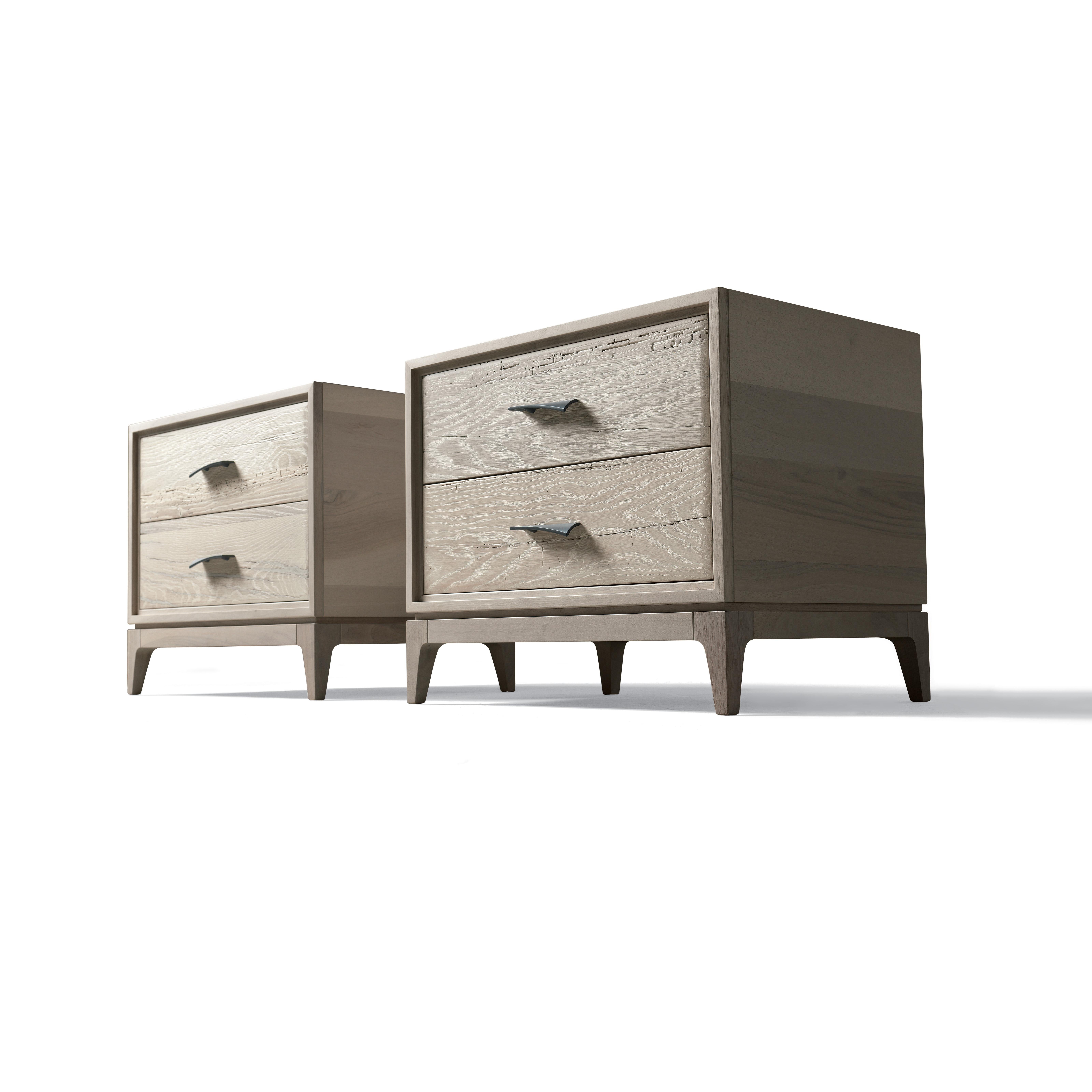 Velo solid wood bedside tables are the result of passion, skills, and refined craftsmanship. They feature structure in solid walnut blockboard and drawers in antique oak with a slightly inclined handle to add personality to the furniture. Thanks to