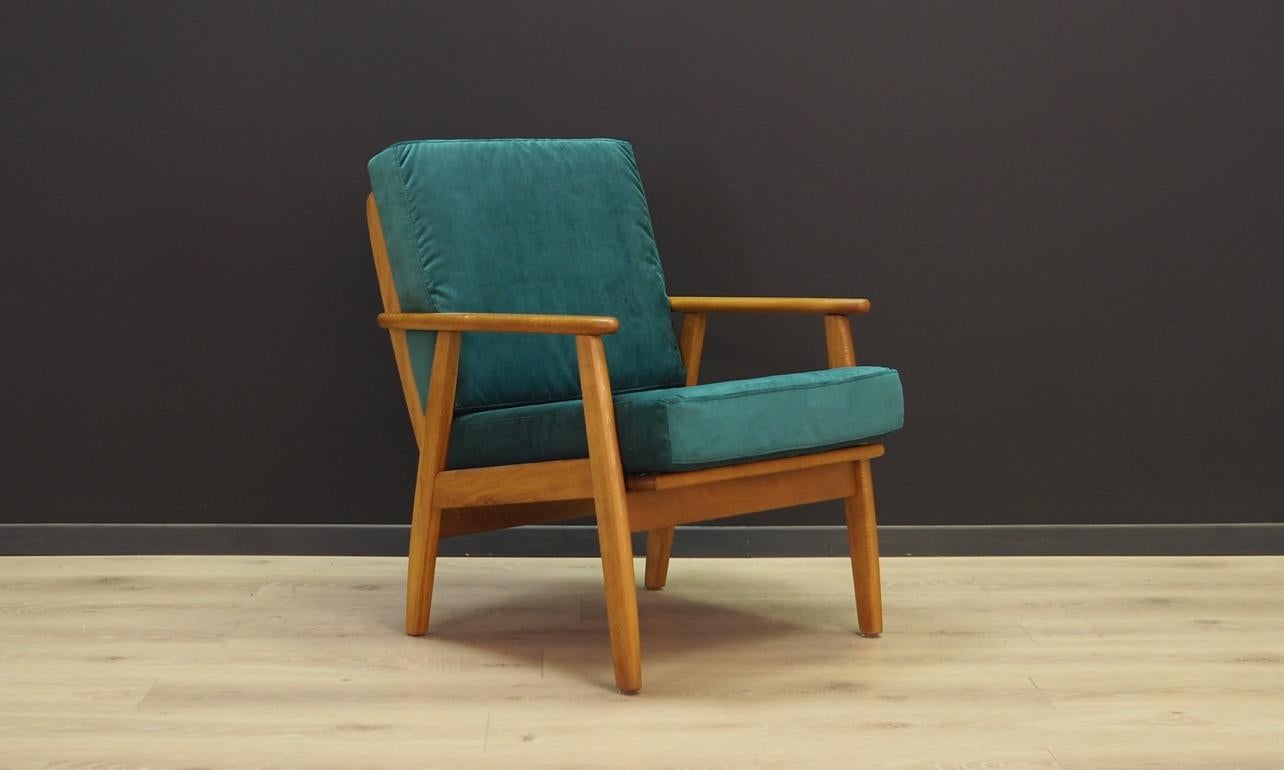 Classic armchair from the 1960s-1970s, Danish design, minimalistic form. The armchair has original upholstery made of velour in green color. The construction is made of solid wood. Preserved in good condition (minor bruises and scratches) - directly