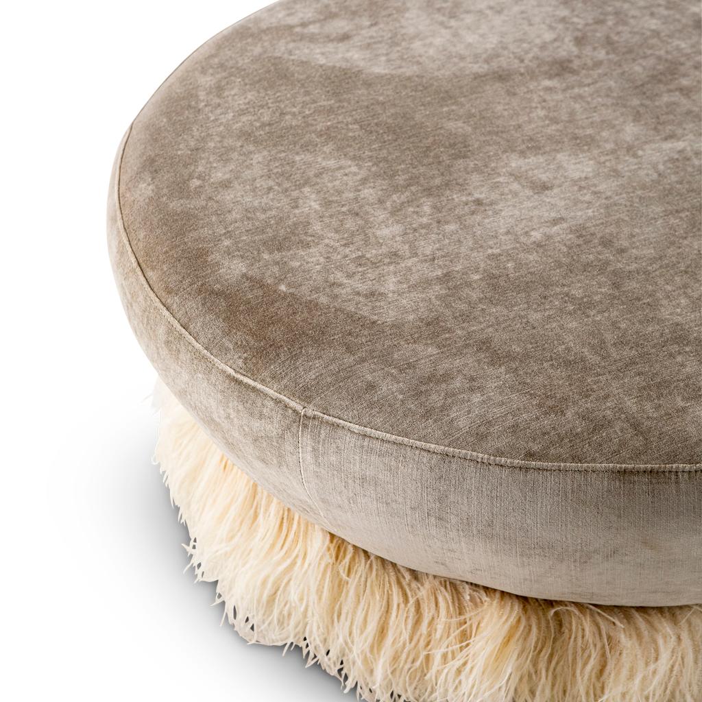 This ottoman is part of the Ostrich Fluff collection designed by Egg Designs and manufactured in South Africa.
The velvet ottoman is finished off with a colored, delicate, genuine ostrich feather skirt trim.