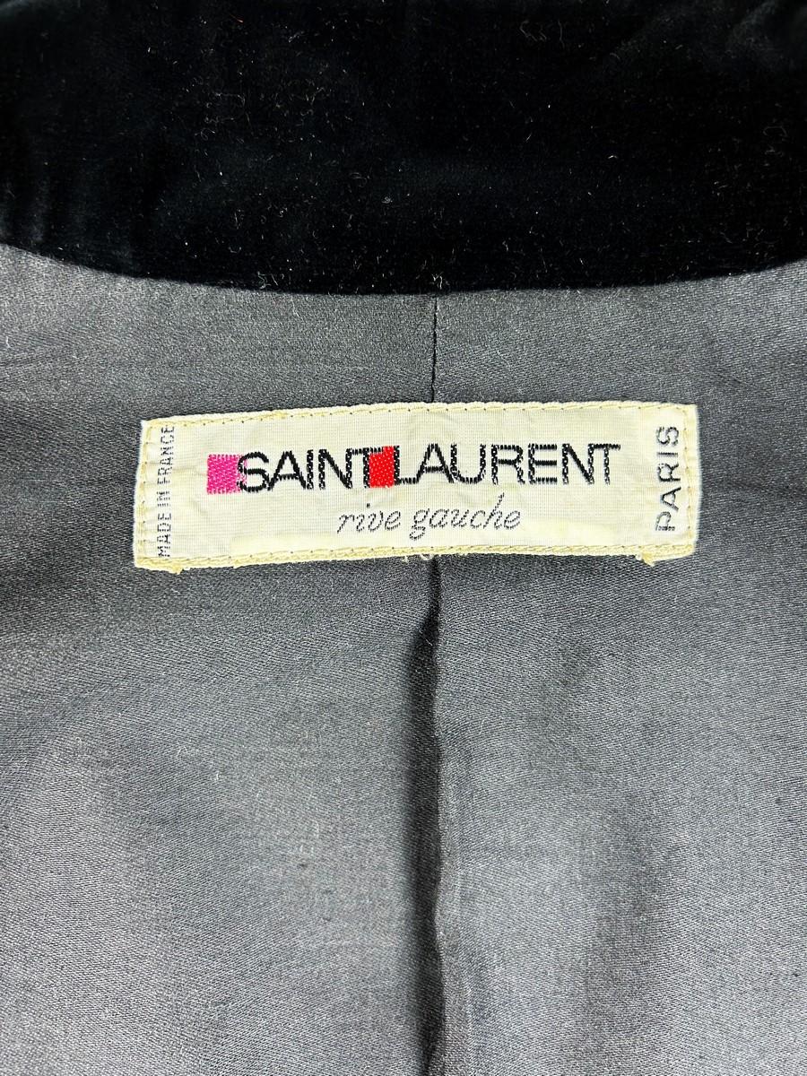 Circa 1976 - 1978
France

Raven black cut velvet coat jacket by Yves Saint Laurent Rive Gauche from the Ballets Russes Opera Collection dating from 1976. Fitted with an officer's collar, long sleeves and black plastic buttons with black cord piping.