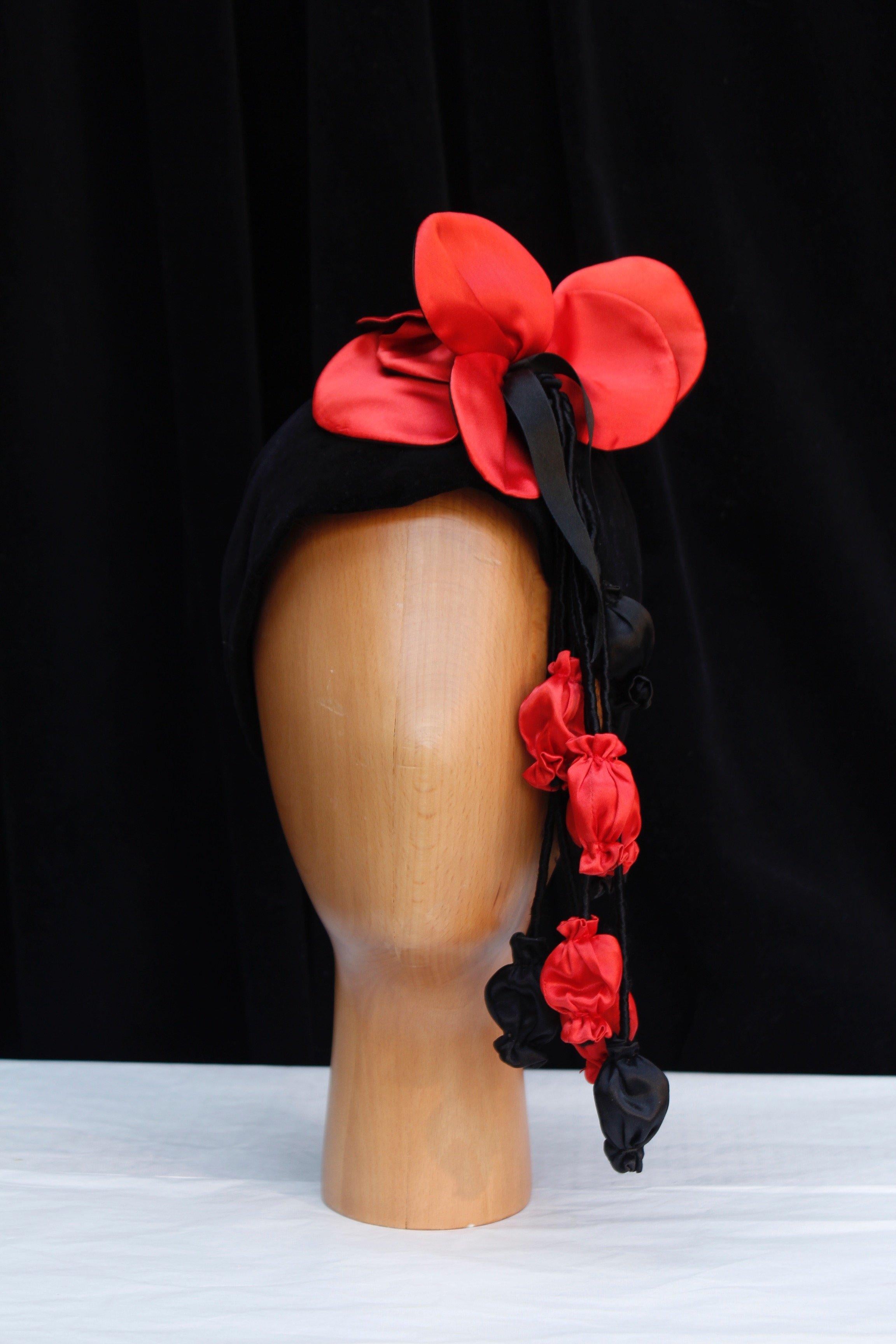ANONYMOUS -Black velvet headband decorated with black and red satin flowers. 

Condition:
Very good condition.

Measurements:
Head circumference: 57 cm (22.44