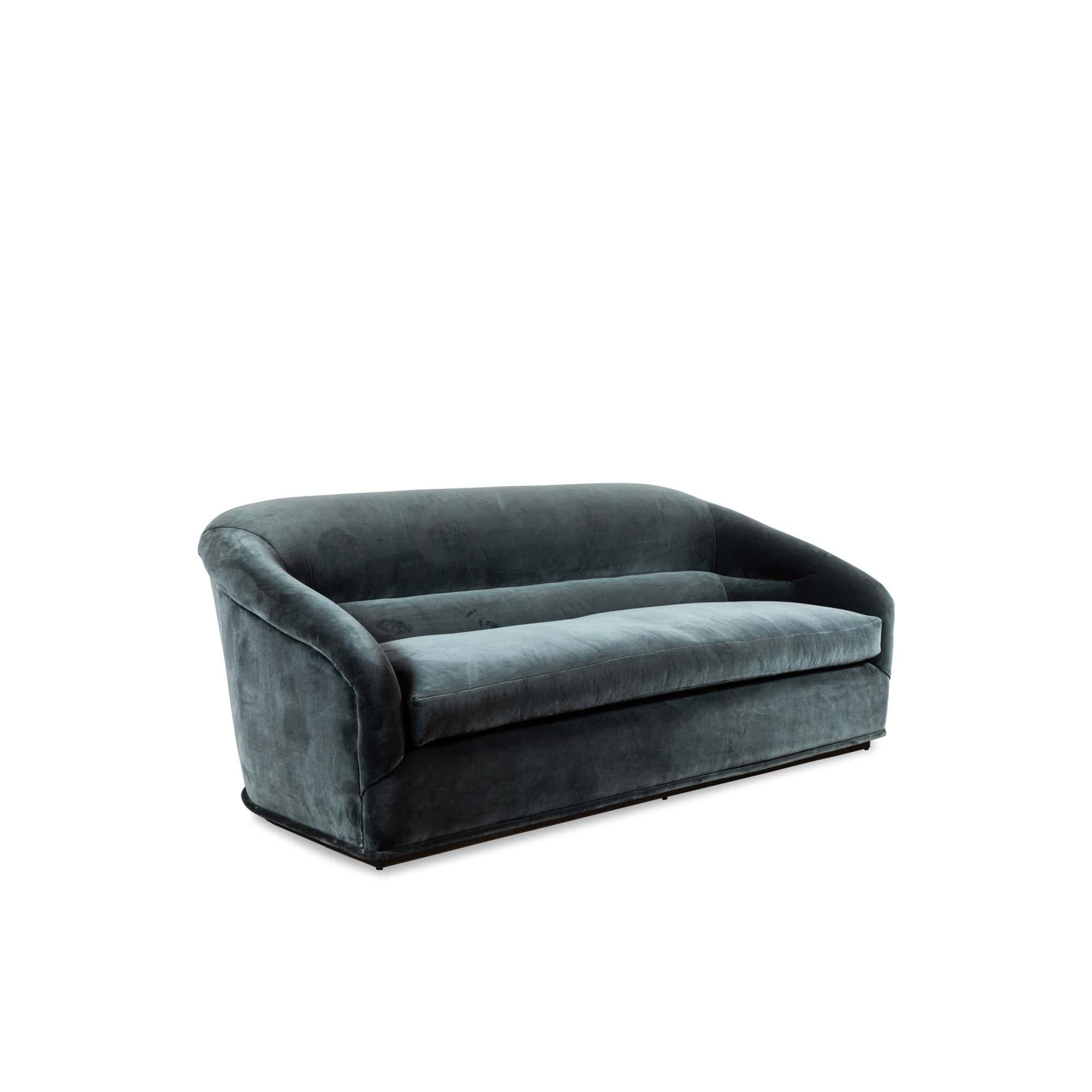 Velvet Huxley sofa by Lawson-Fenning. The Huxley sofa is inspired by 1970s lounge furniture. A curvaceous form with a single line tuft and long seat cushion rest atop a polished brass base. 

The Lawson-Fenning Collection is designed and handmade