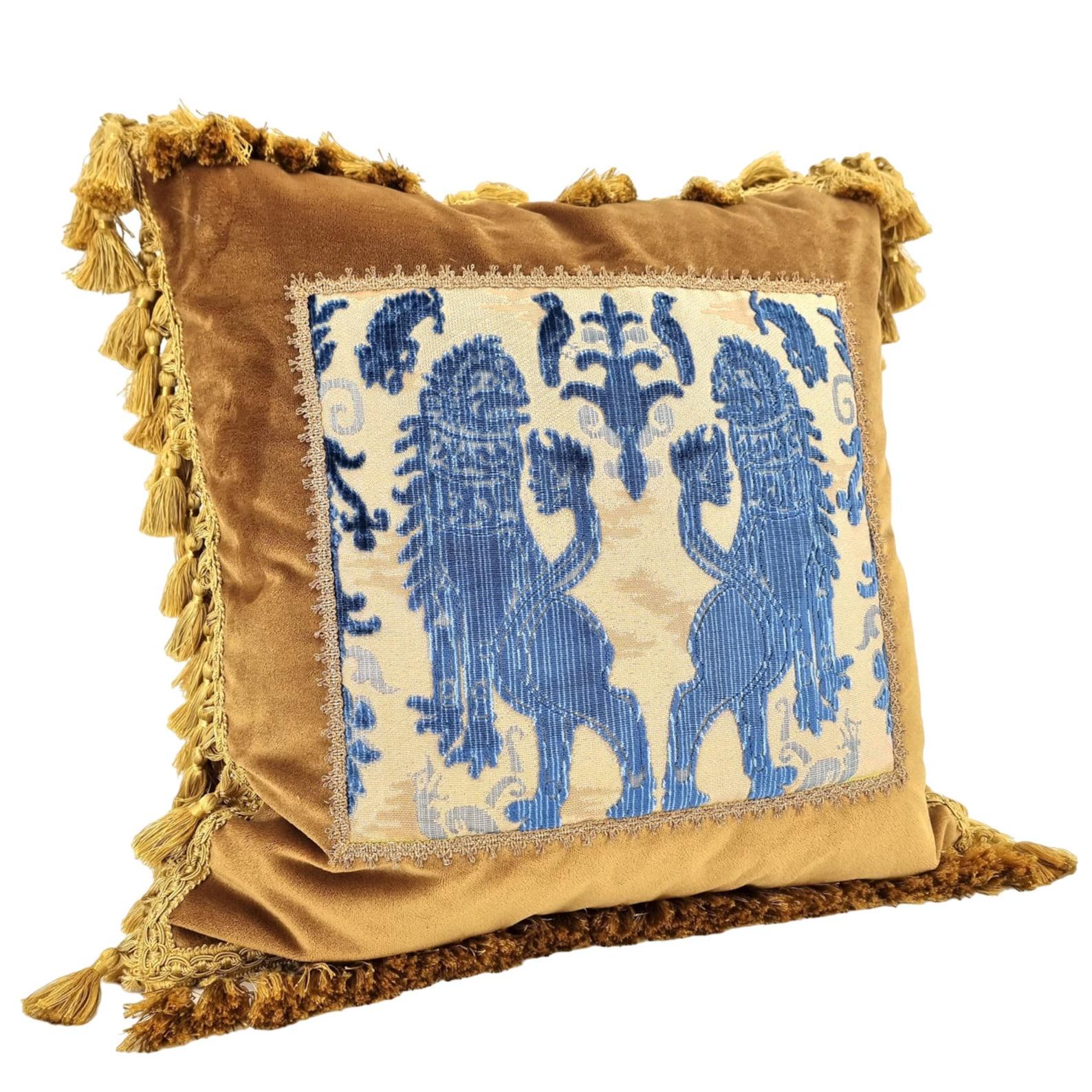 This amazing decorative pillow with gold tassel trim all around the four edges is handmade using Rubelli velvet in antique gold color embellished with front positioned panel in Luigi Bevilacqua indigo blue silk heddle velvet 