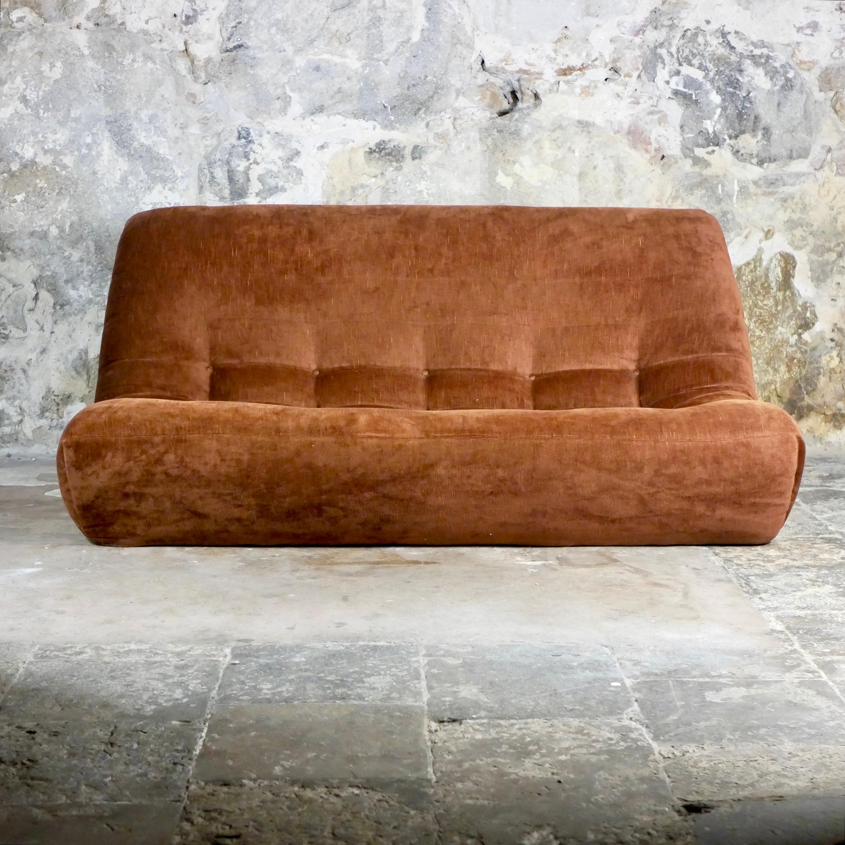 Rare velvet lounge set from France, made in the 1970s, in the style of Michel Ducaroy’s Togo.
Composed of a 3-seats sofa and an armchair.
Foam and original velvet fabric.
Good condition overall, one stitch in the back of the sofa, fading (also in